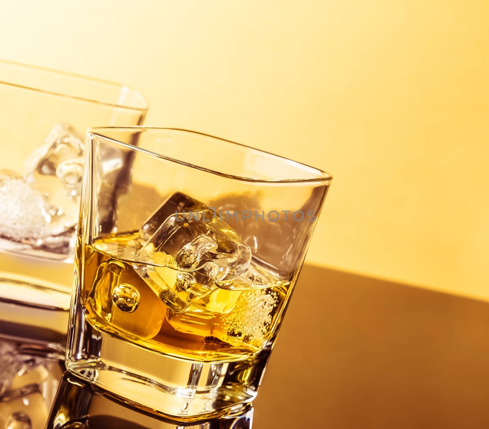 two glasses of whiskey on table with reflection, warm atmosphere, time of relax with whisky
