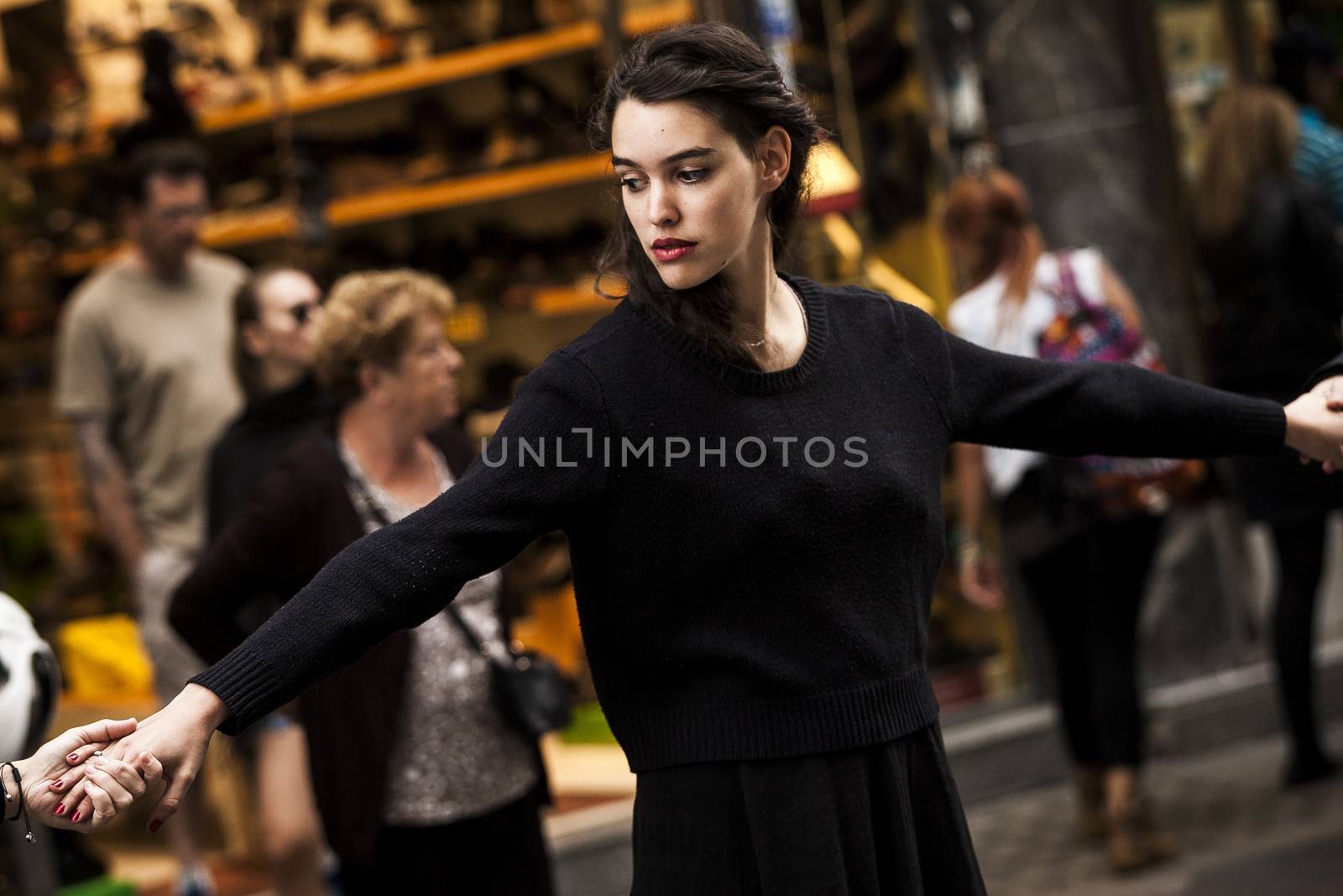 SPAIN, Madrid: A woman dressed in all black protests and feigns her own death in downtown Madrid as part of a performance protest, on October 2, 2015, denouncing gender-based violence. 