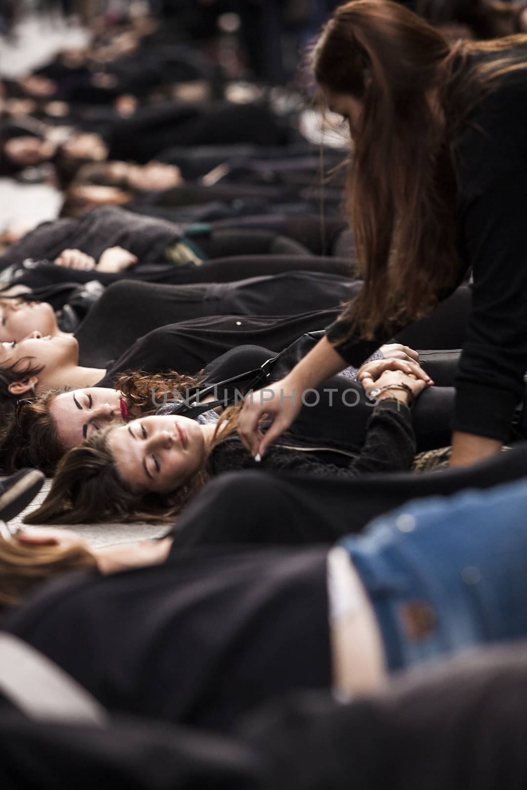 SPAIN, Madrid: Women dressed in all black feign their own death in downtown Madrid as part of a performance protest, on October 2, 2015, denouncing gender-based violence. 