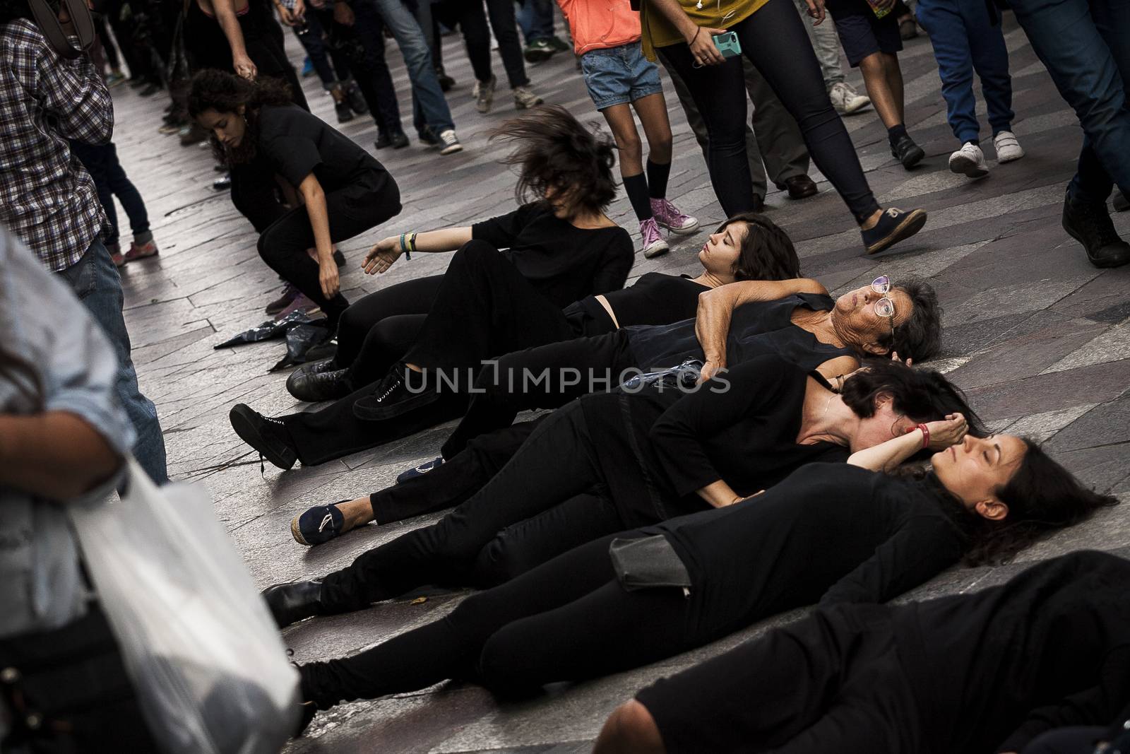SPAIN, Madrid: Women dressed in all black feign their own death in downtown Madrid as part of a performance protest, on October 2, 2015, denouncing gender-based violence. 