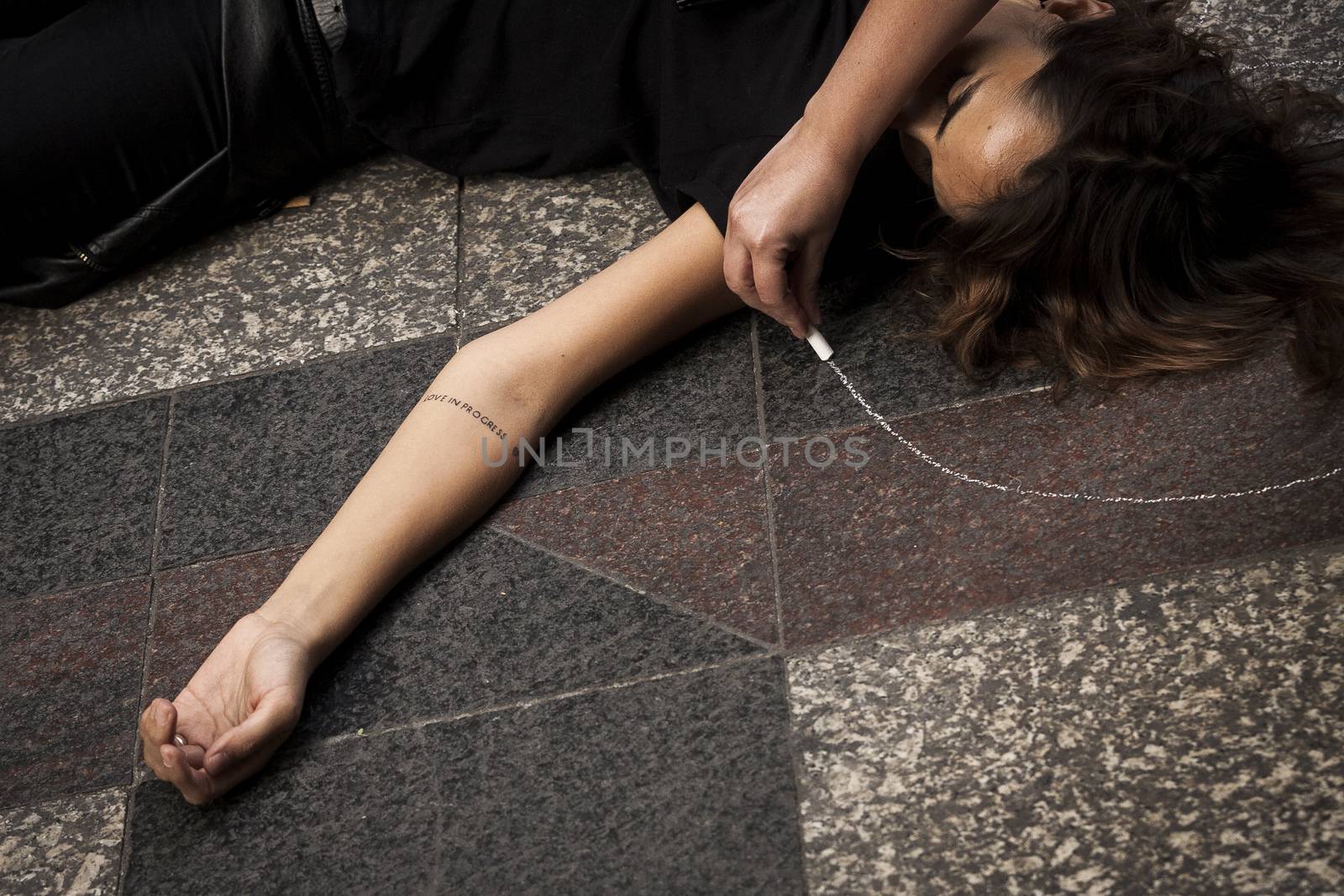 SPAIN, Madrid: A woman dressed in all black feigns her own death in downtown Madrid as part of a performance protest, on October 2, 2015, denouncing gender-based violence. 