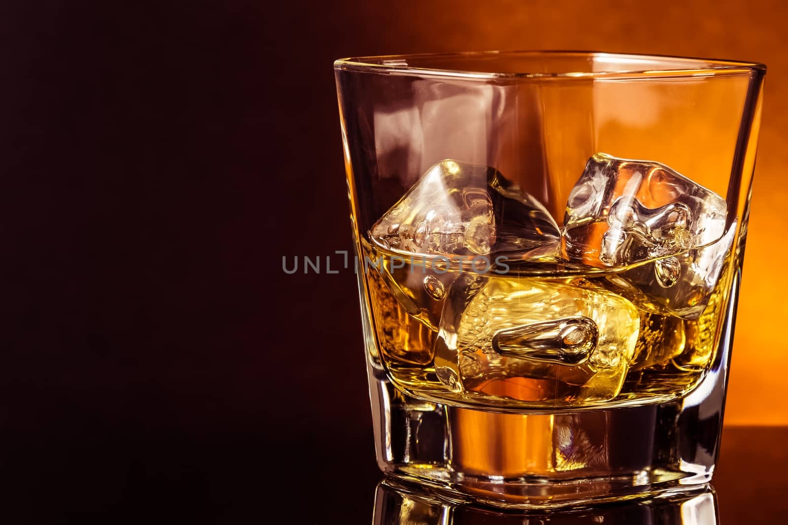 glass of whiskey on black table with reflection, warm atmosphere, time of relax with whisky with space for text