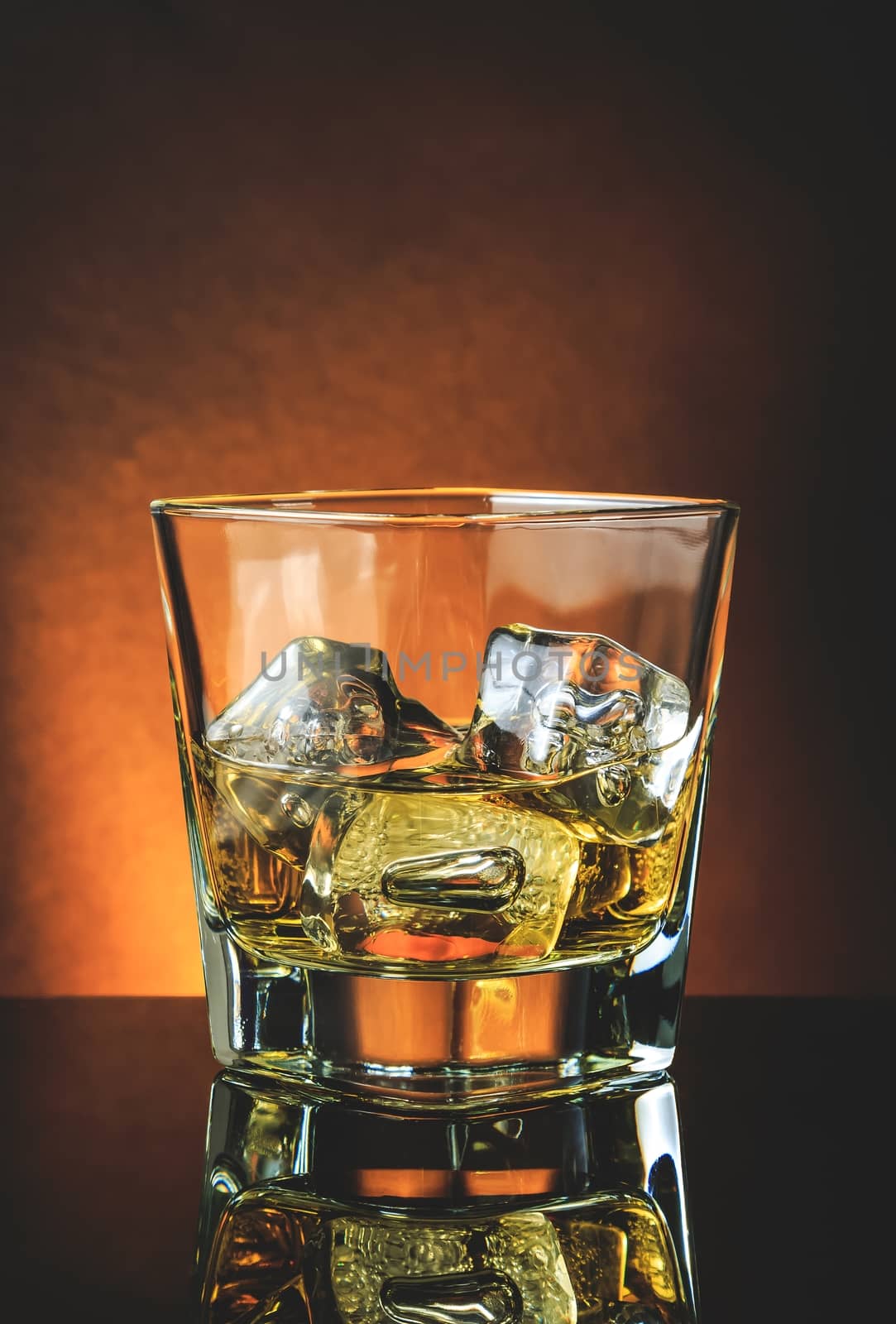 glass of whiskey on black table with reflection, warm atmosphere, time of relax with whisky