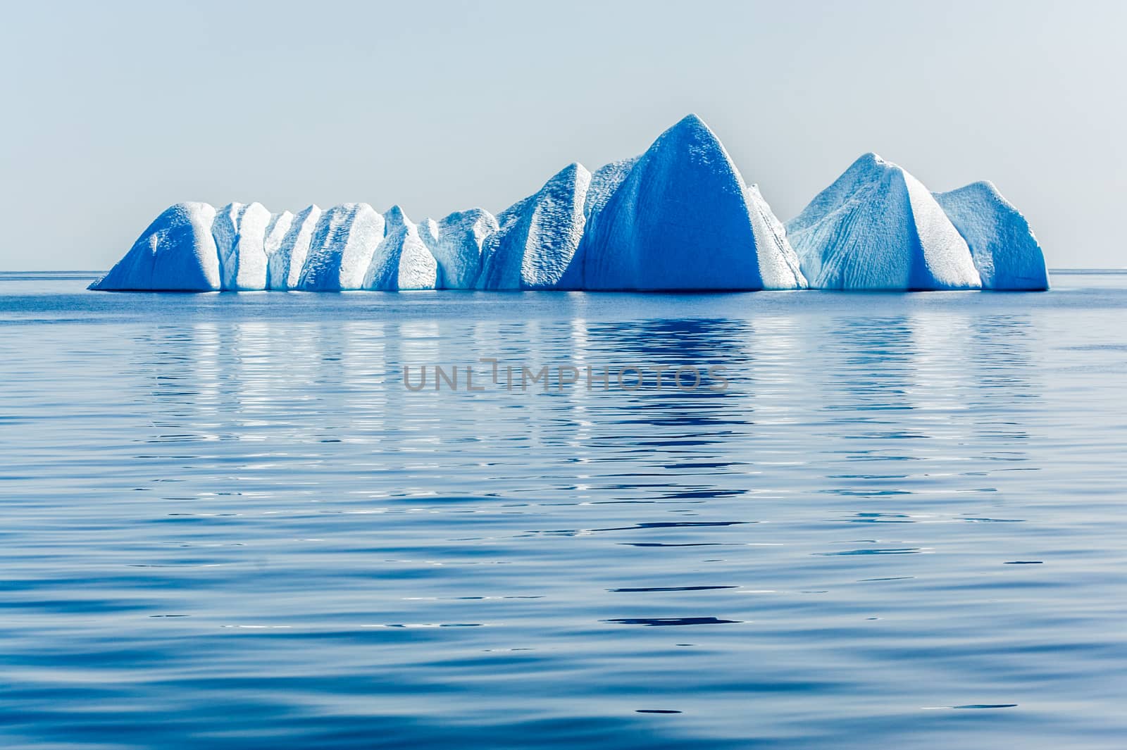 Lone Ice Bergs Float in The Ice Blue Arctic Sea