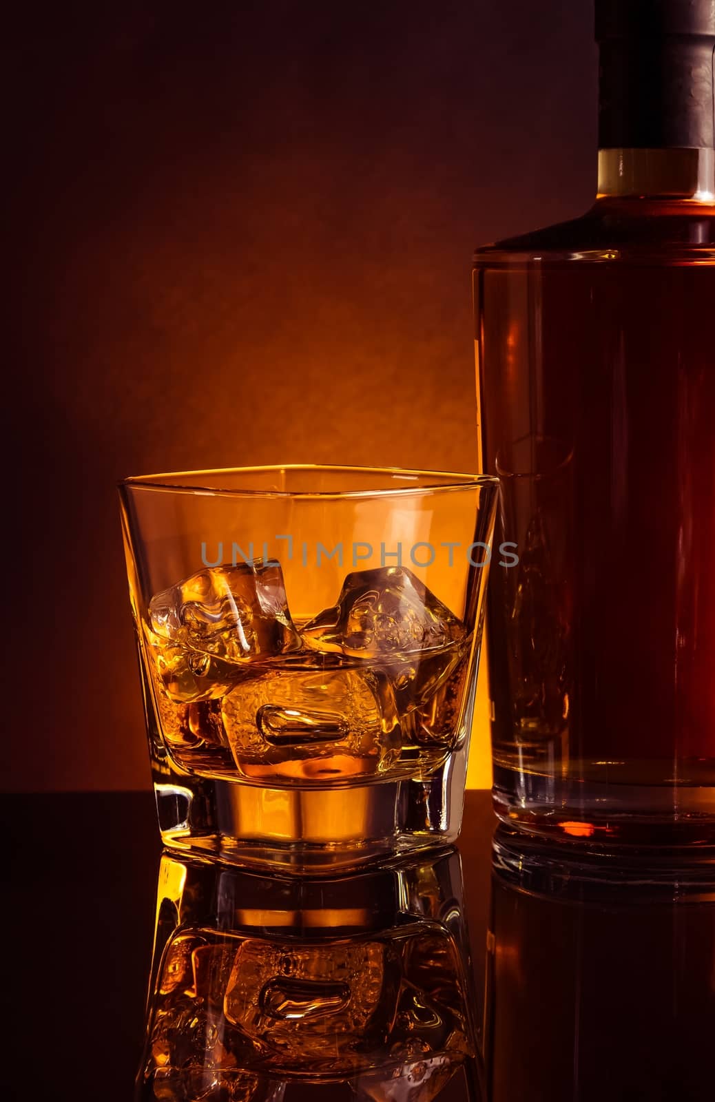 glass of whiskey near bottle on black table with reflection, warm tint atmosphere, time of relax with whisky