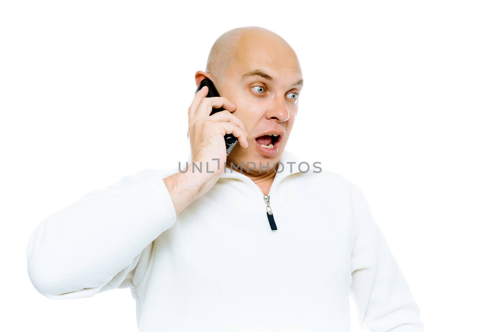 Bald man emotionally communicates by phone. Isolated on white. Studio