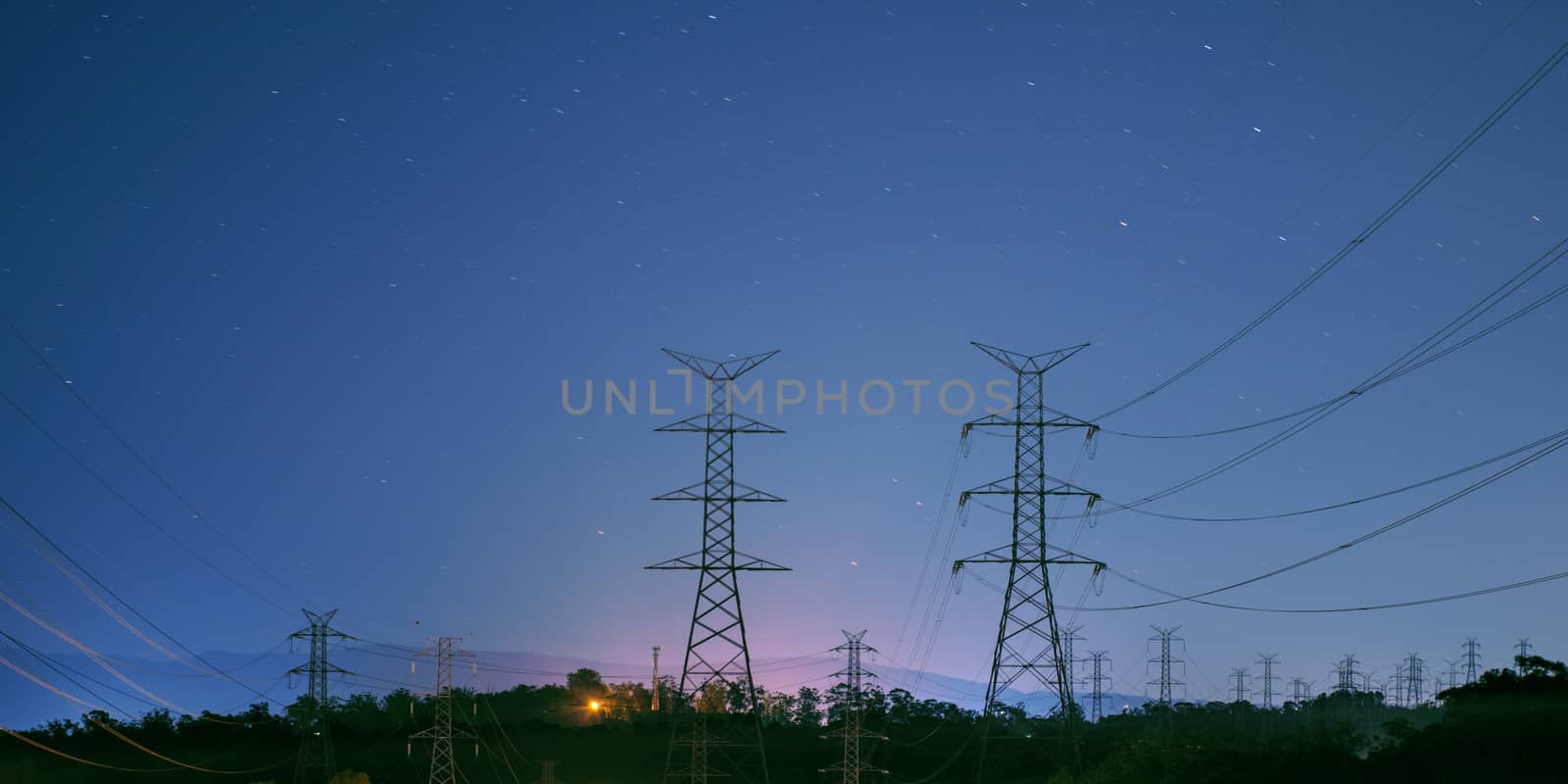 High voltage power tower at night with stars in the background in Brisbane, Queensland. 