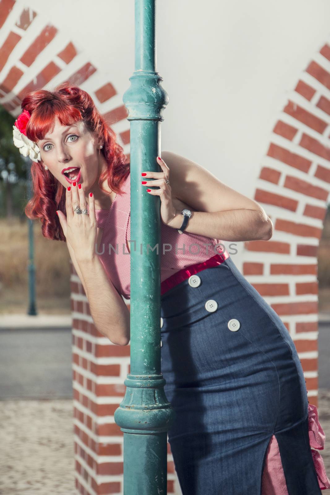 View of pinup young woman in vintage style clothing surprised.