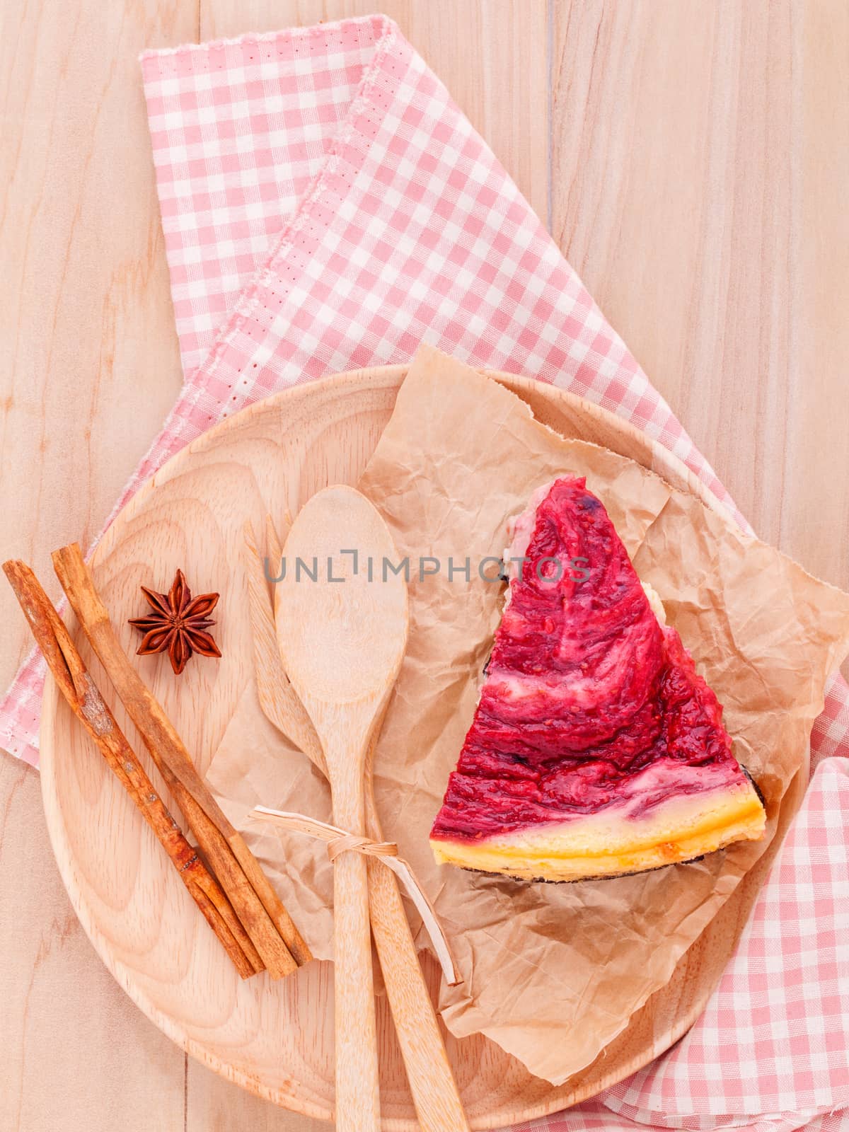 Homemade raspberry cake with cup of coffee on wooden background.