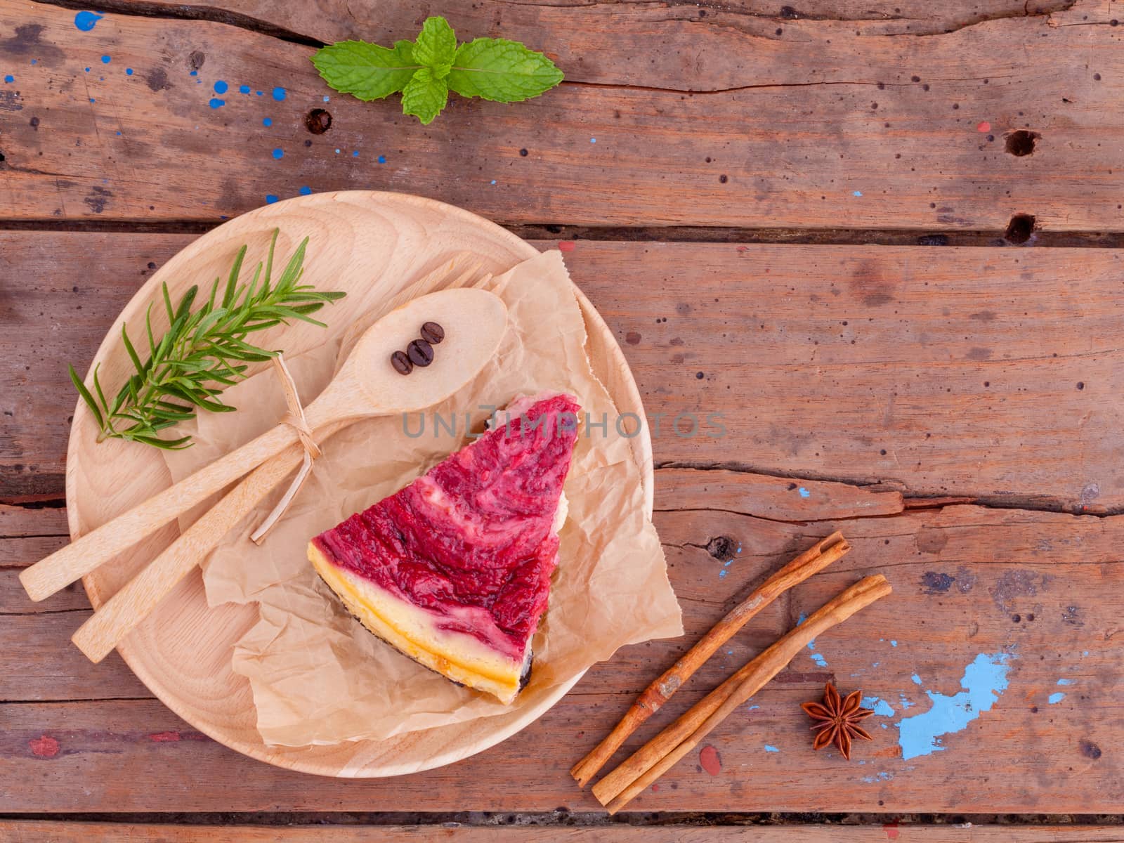 Homemade raspberry cake with cup of coffee on wooden background.