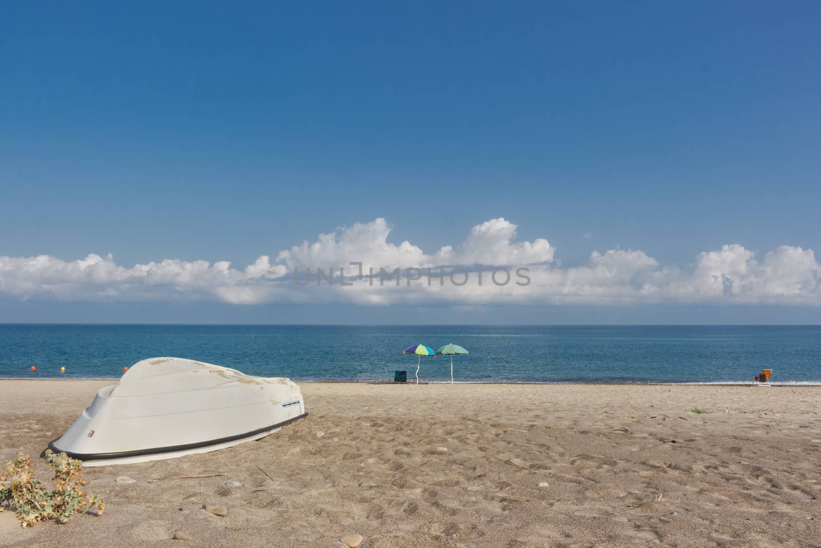 The boat on the lonely beach of fine sand