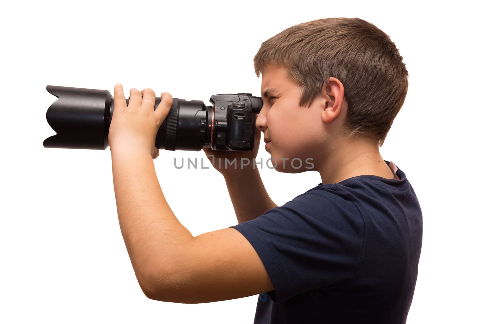 the photograph depicts a young boy with a camera