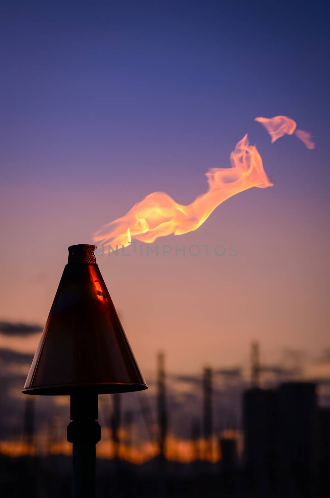 Retro Style Image Of A Hawaiian Tiki Torch By The Coast In Honolulu At Sunset