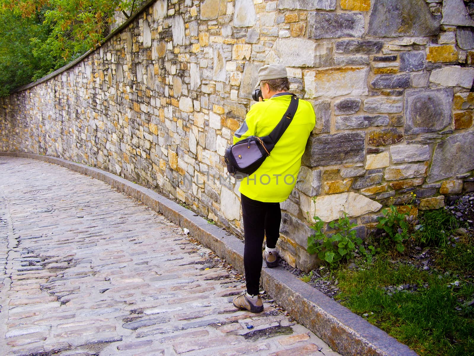 Colorful senior photographer at rampart walls of Old Quebec