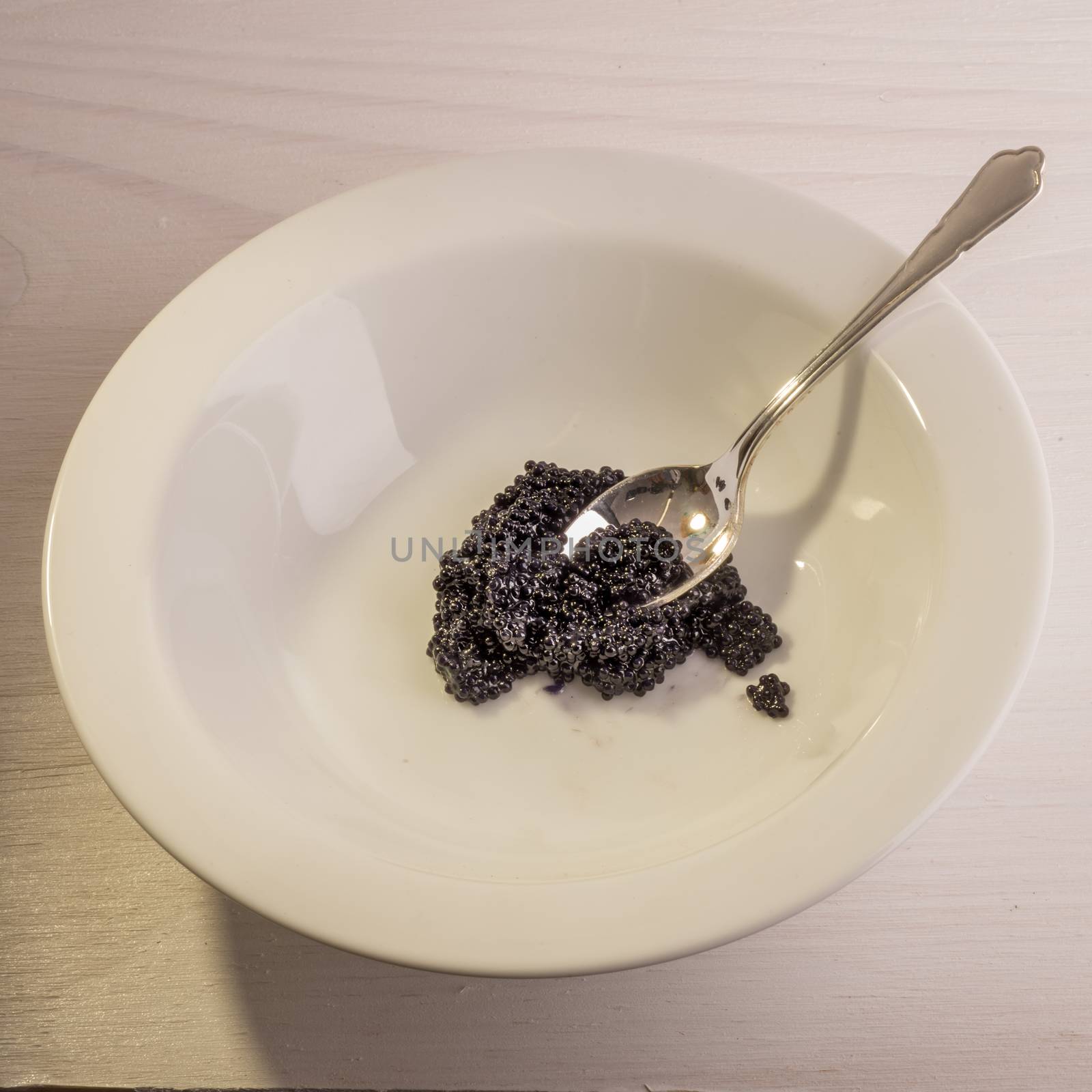 Silver Spoon and Caviar in White Bowl by JFJacobsz