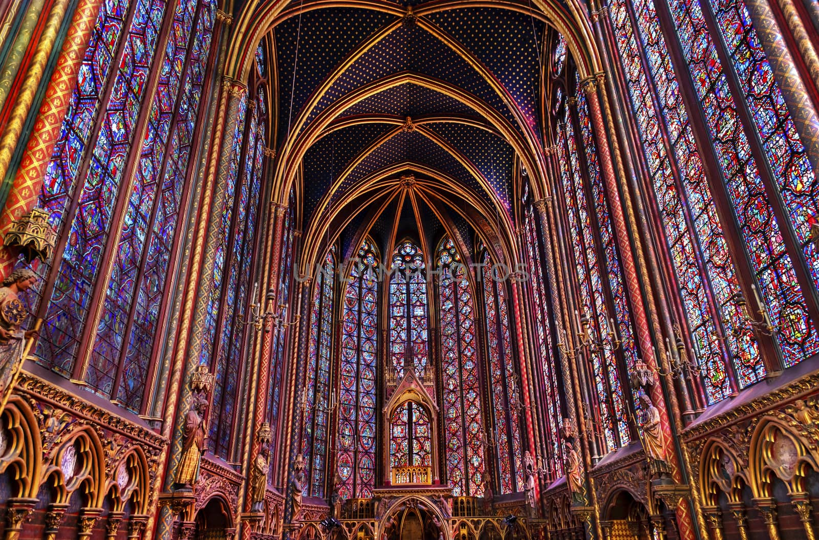 Stained Glass Cathedral Saint Chapelle Paris France.  Saint King Louis 9th created Sainte Chapelle in 1248 to house Christian relics, including Christ's Crown of Thorns.  Stained Glass created in the 13th Century and shows various biblical stories along with stories from 1200s.