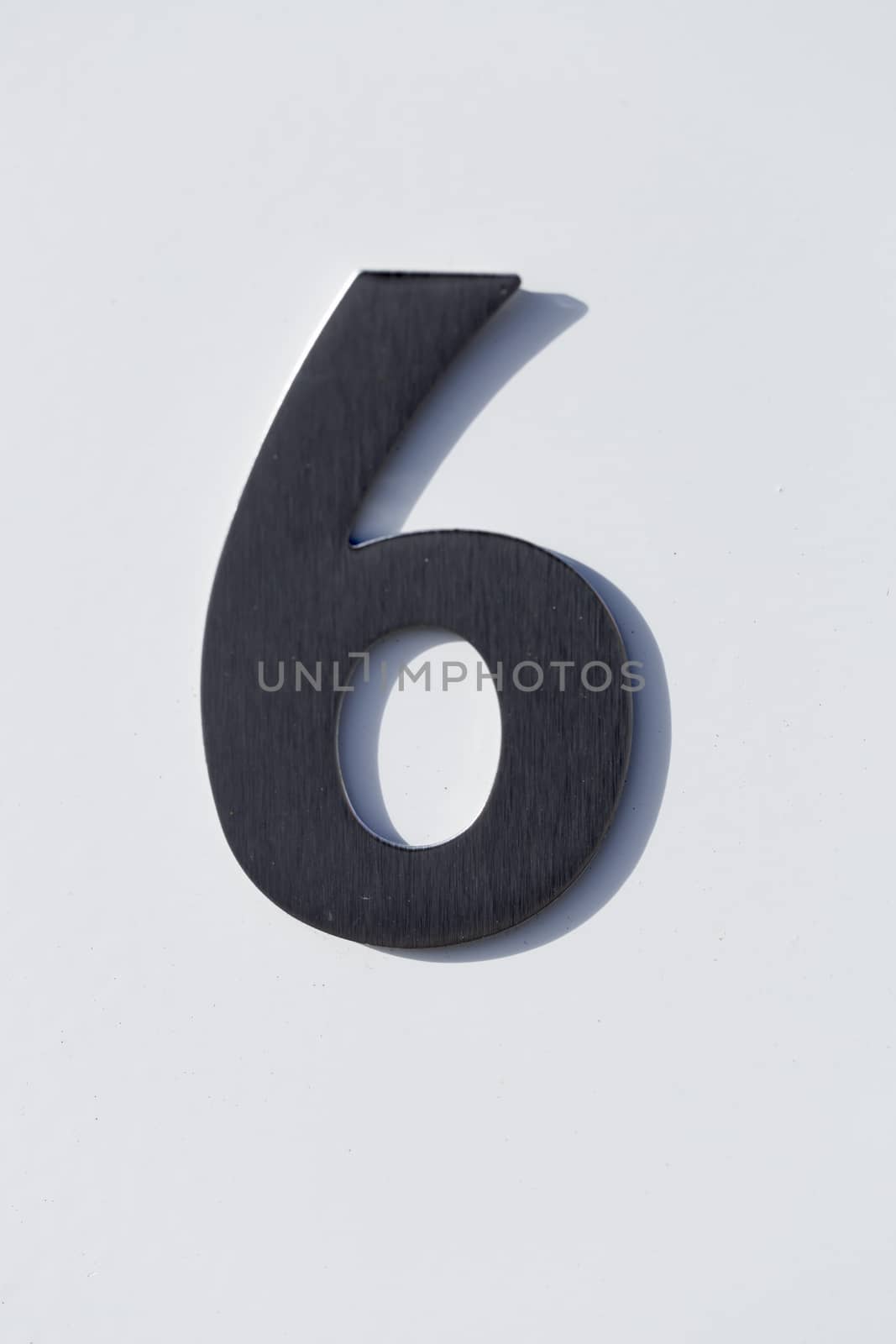 Number 6 on a Post Box with white backgound.