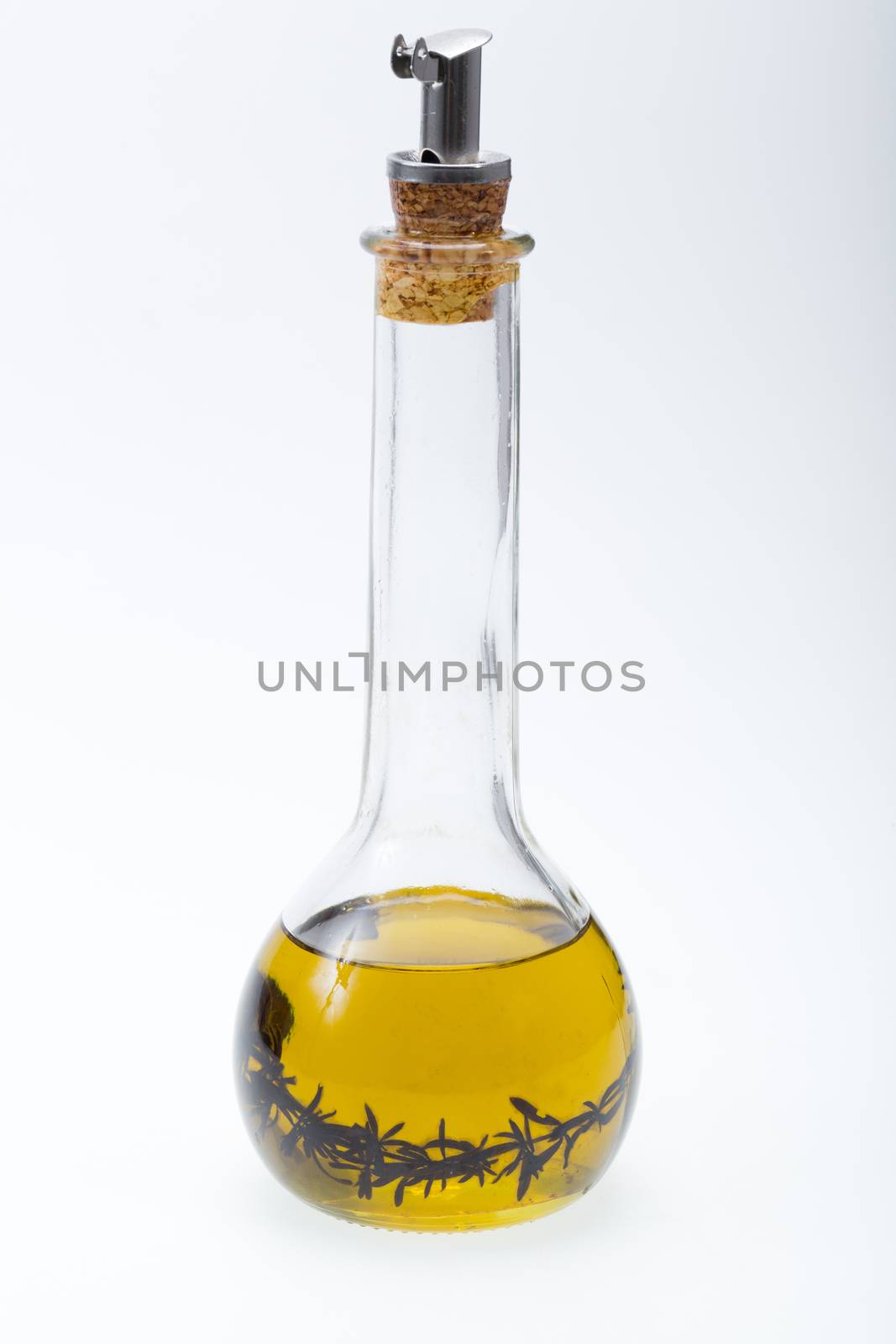 Thyme infused olive oil over white background 