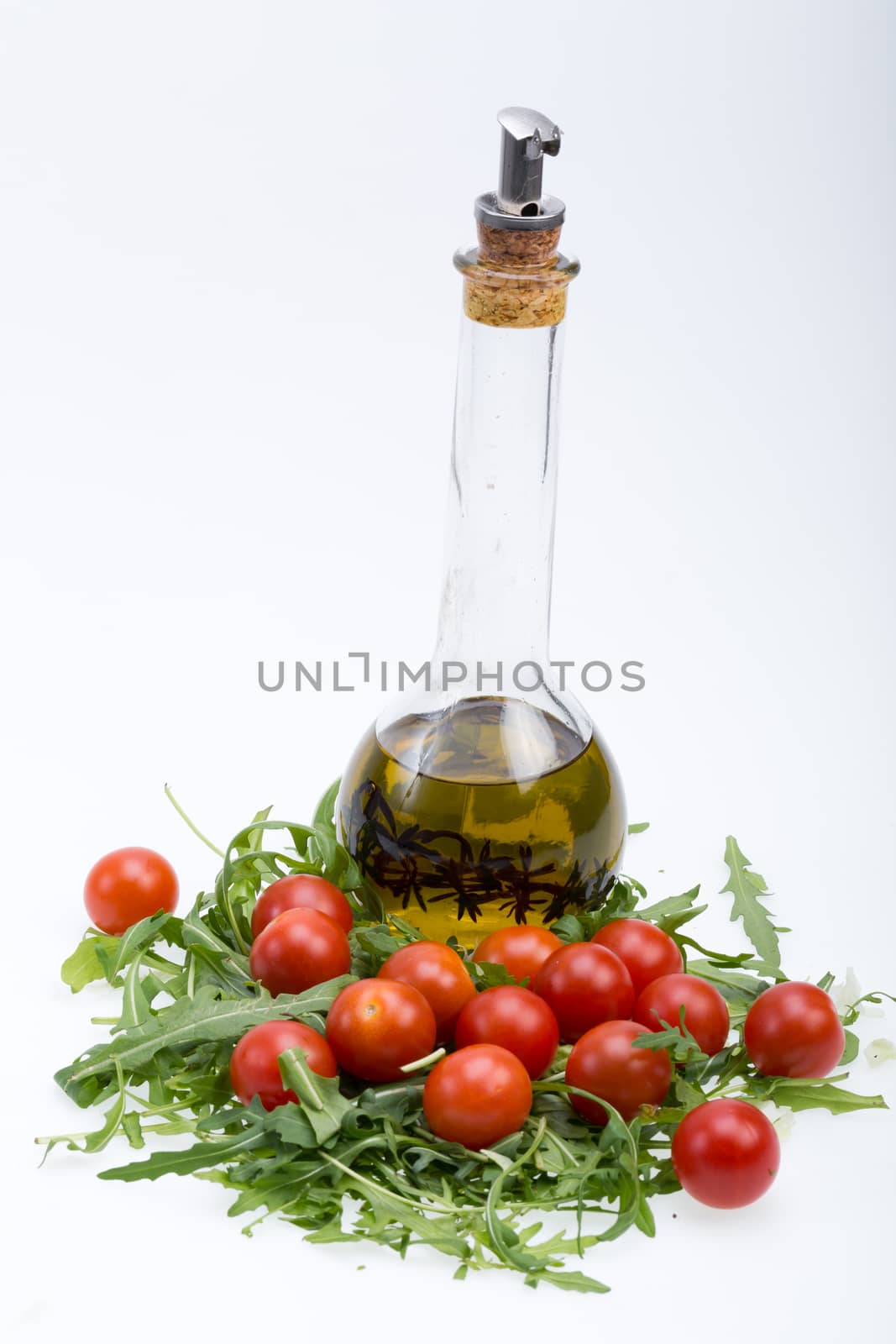 Heap of ruccola, tomatoes and olive oil with the thyme by wjarek
