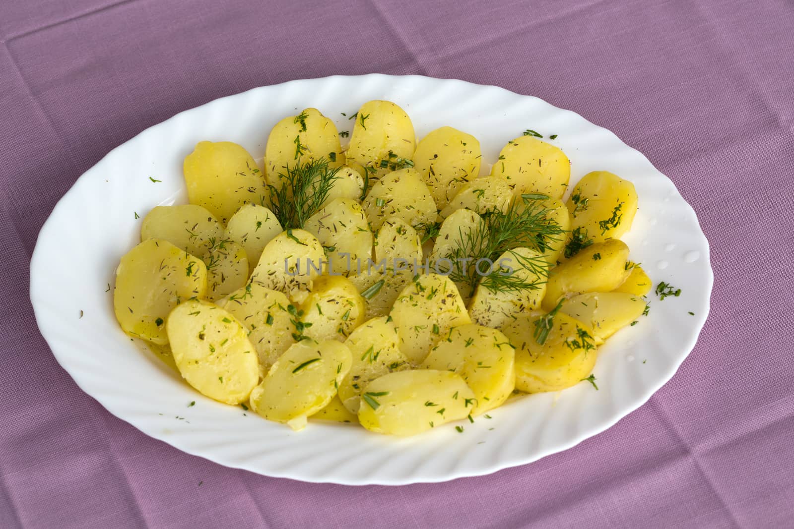 Delicious boiled potatoes with dill and olive