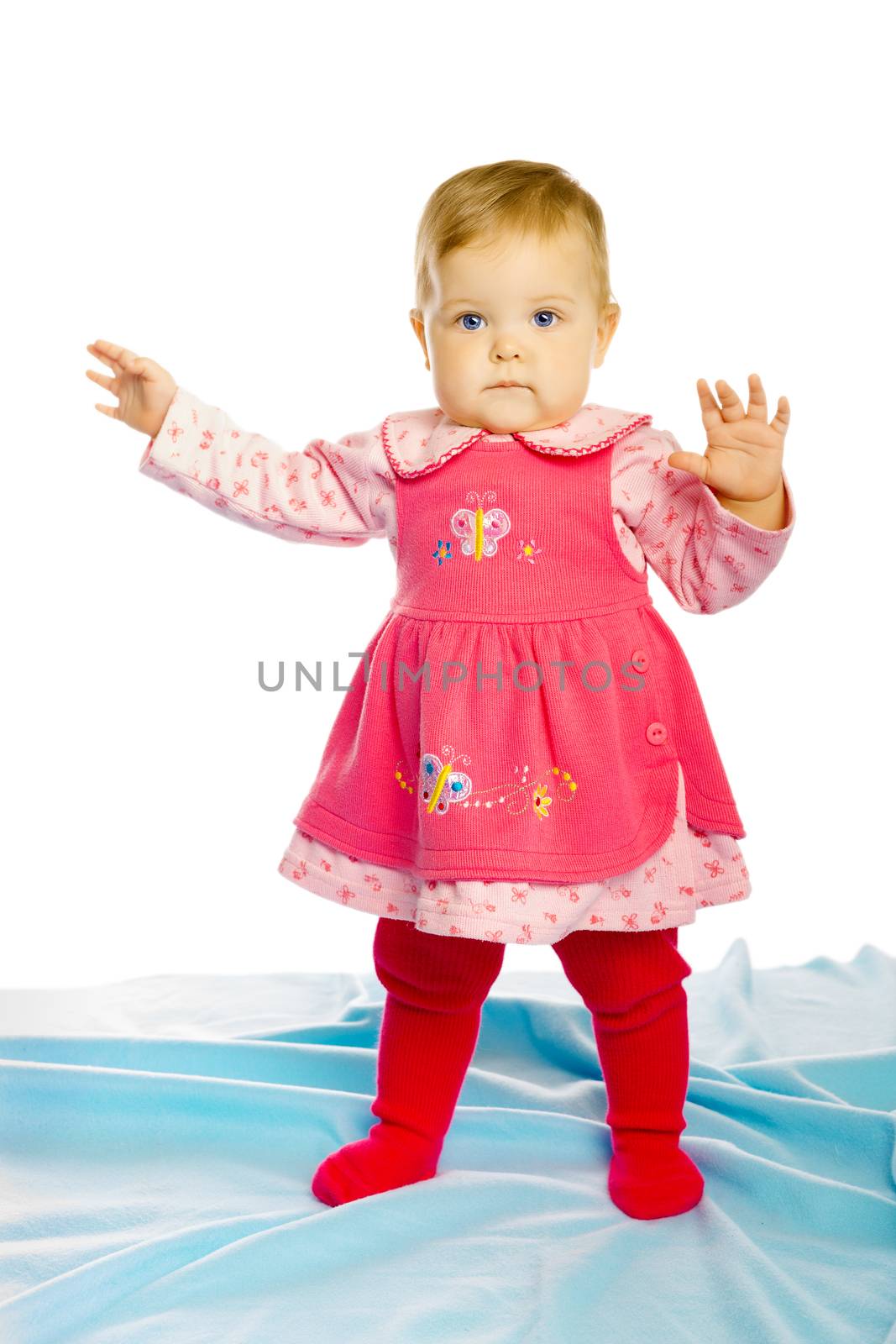 baby girl in a dress standing by pzRomashka