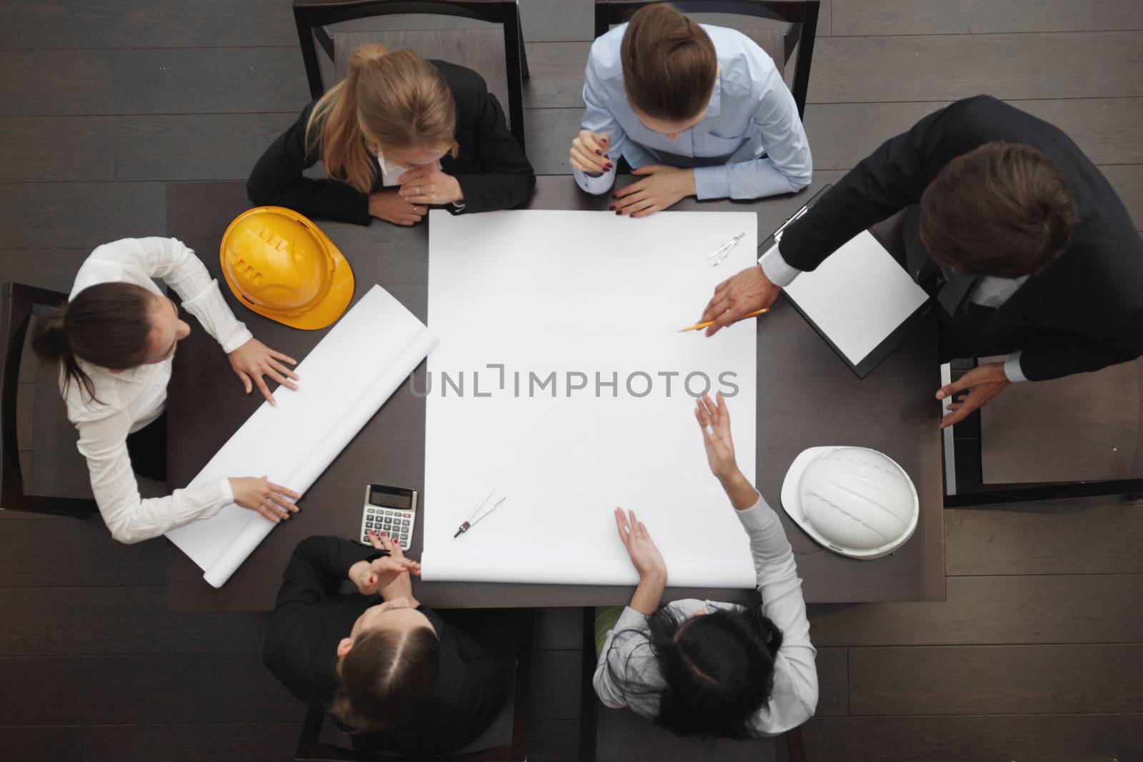 Top view of people around table in construction business meeting