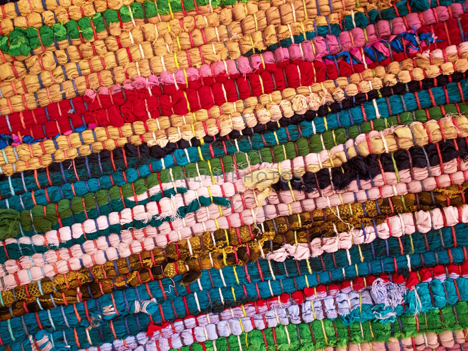 Closeup view of a colorful hand made woven rug mat      