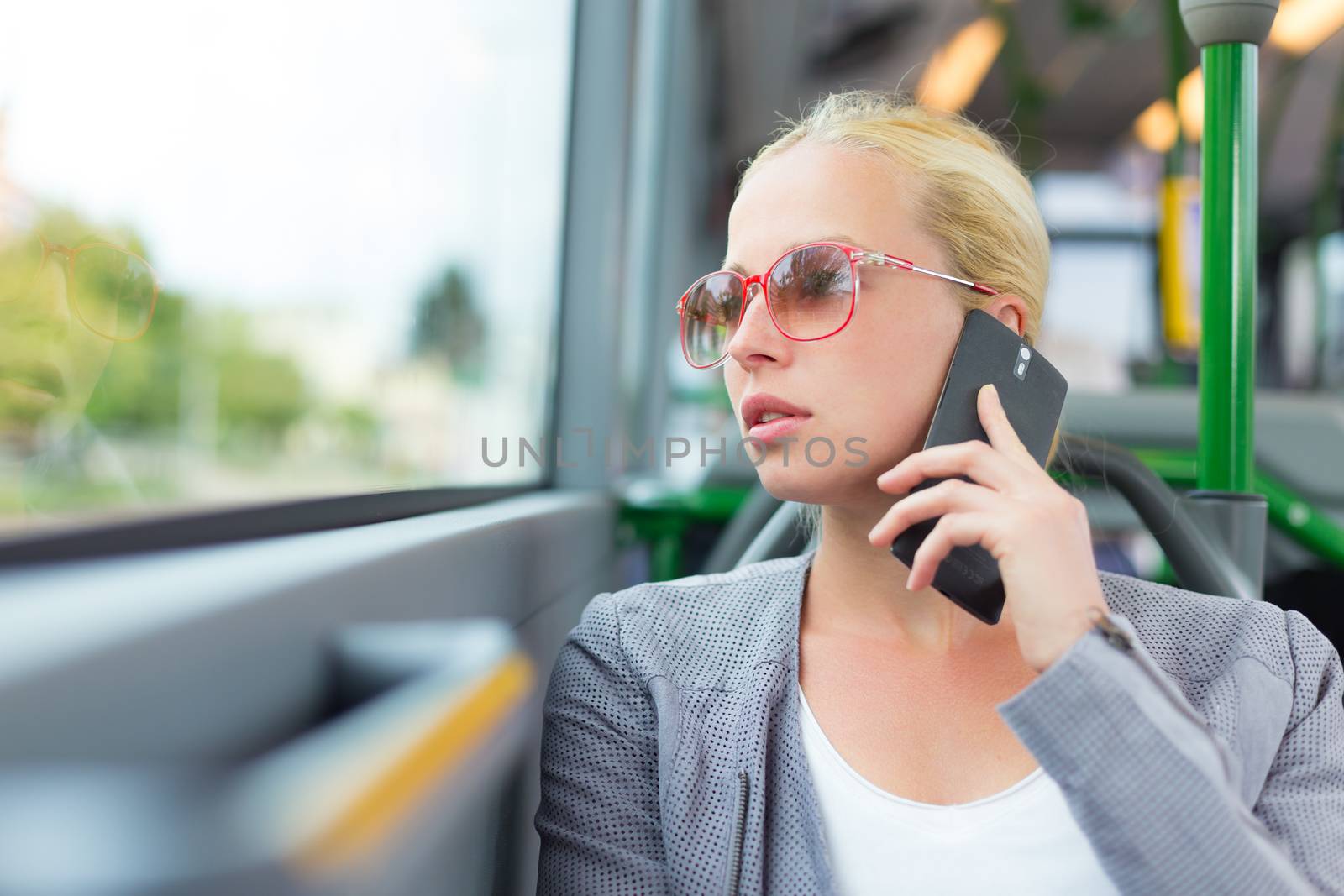 Blonde business woman traveling by bus. by kasto