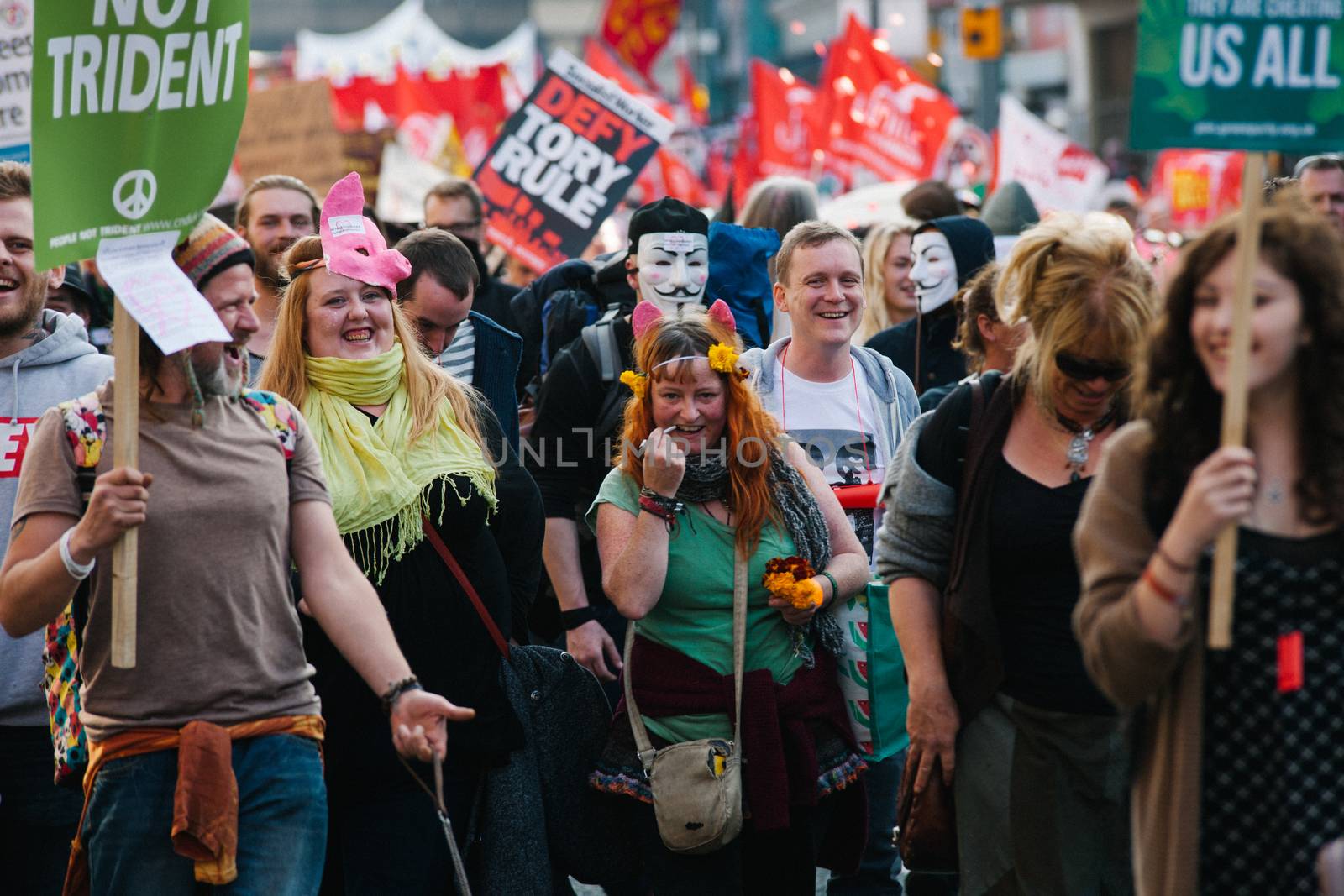 UNITED KINGDOM, Manchester: Protesters holding placards are seen during an anti-austerity march organized by The Peoples Assembly in protest against the Conservative Party Conference in Manchester, United Kingdom on October 4, 2015. The demonstrators were protesting against cuts on benefits, National Health System reforms and restriction on the ability for trade unions to go on strike.  