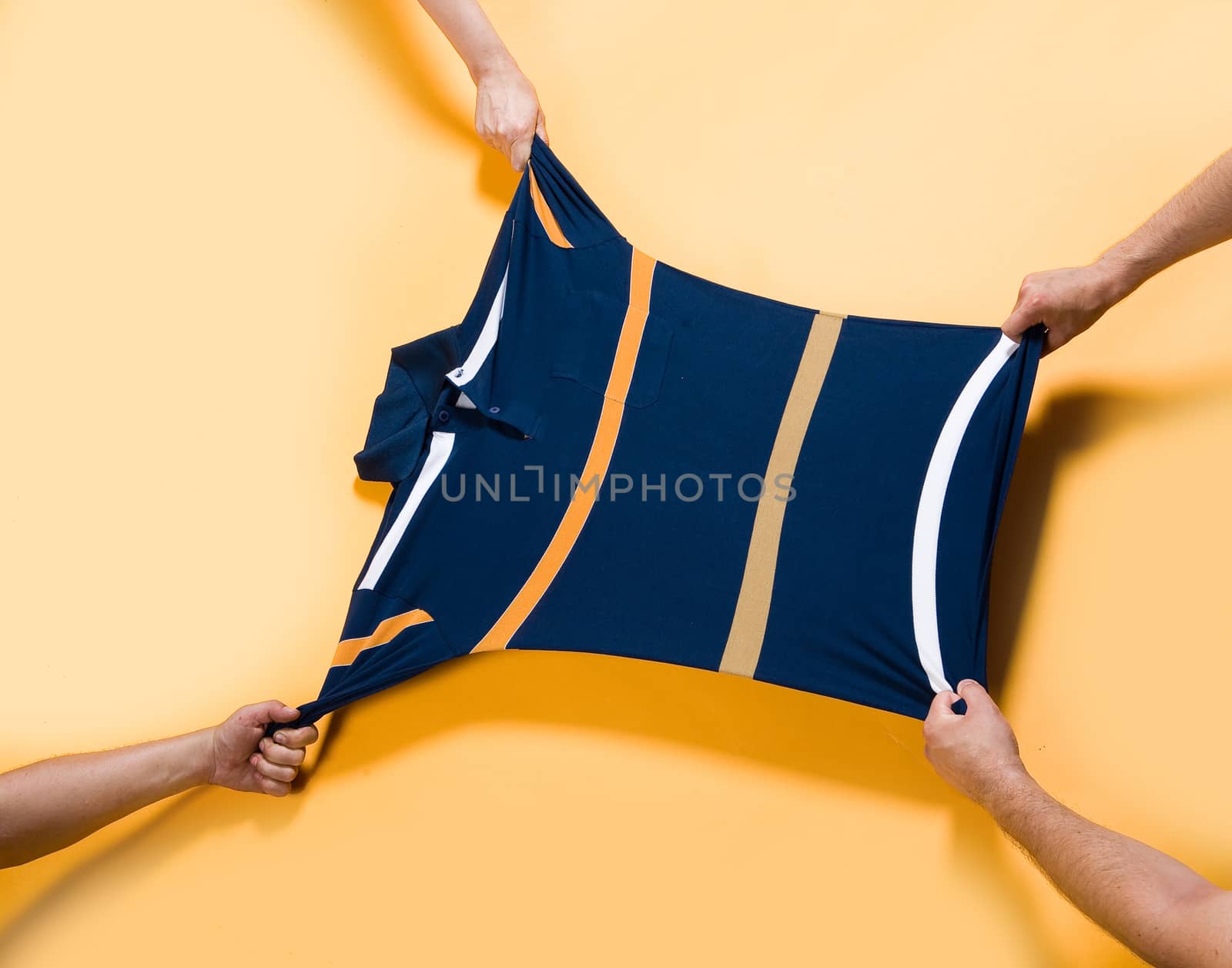 Four hands pulling the shirt
