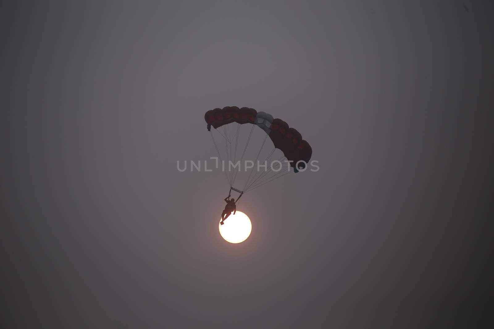 MALAYSIA, Kuala Lumpur: Base jumper silhouetted by sun through haze	Heavy haze didn't deter the 120 thrill-seeking base jumpers as they leapt into the foggy abyss off Kuala Lumpur Tower on October 3, 2015.  	The participants were joining others across the world on the 15th�International Base Jump Day. 