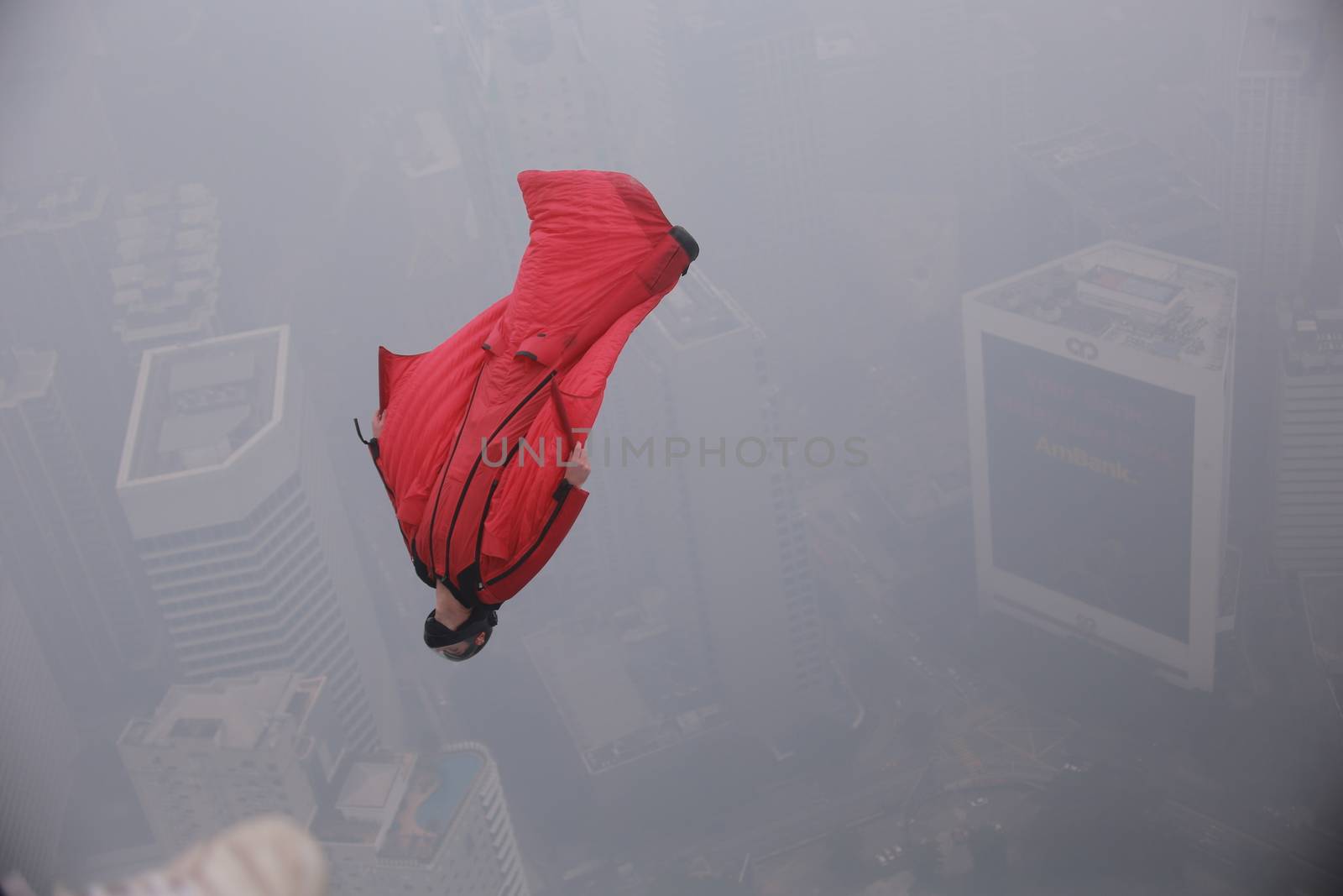 MALAYSIA, Kuala Lumpur: Squirrel suit jumper 	Heavy haze didn't deter the 120 thrill-seeking base jumpers as they leapt into the foggy abyss off Kuala Lumpur Tower on October 3, 2015.  	The participants were joining others across the world on the 15th�International Base Jump Day. 