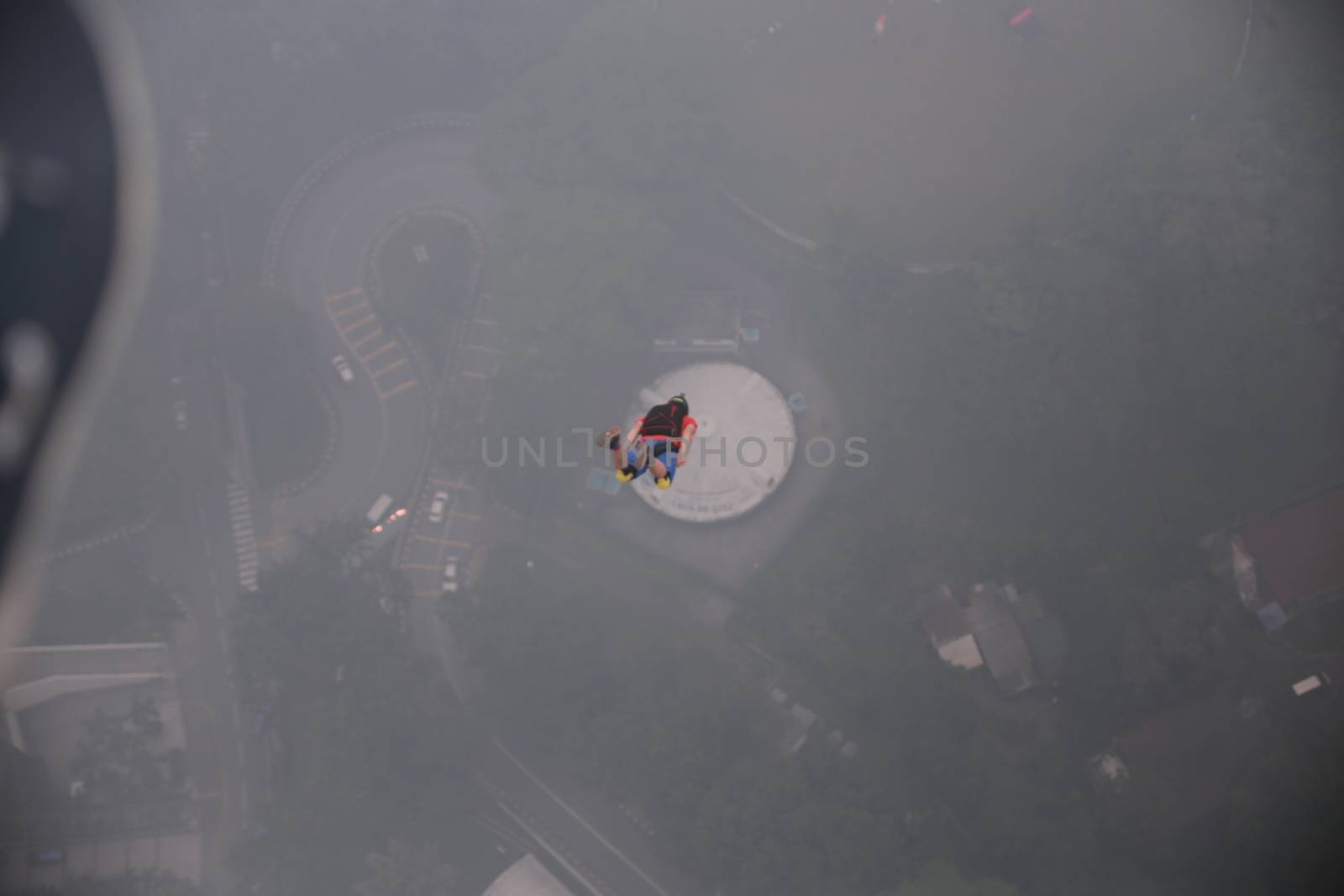 MALAYSIA, Kuala Lumpur: Base jumper speeds down off tower	Heavy haze didn't deter the 120 thrill-seeking base jumpers as they leapt into the foggy abyss off Kuala Lumpur Tower on October 3, 2015.  	The participants were joining others across the world on the 15th�International Base Jump Day. 