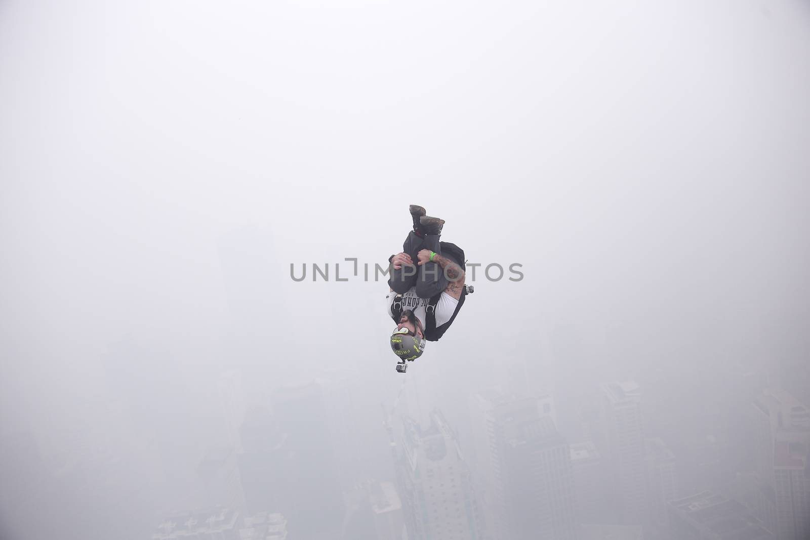 MALAYSIA, Kuala Lumpur: Base jumper 	Heavy haze didn't deter the 120 thrill-seeking base jumpers as they leapt into the foggy abyss off Kuala Lumpur Tower on October 3, 2015.  	The participants were joining others across the world on the 15th�International Base Jump Day. 