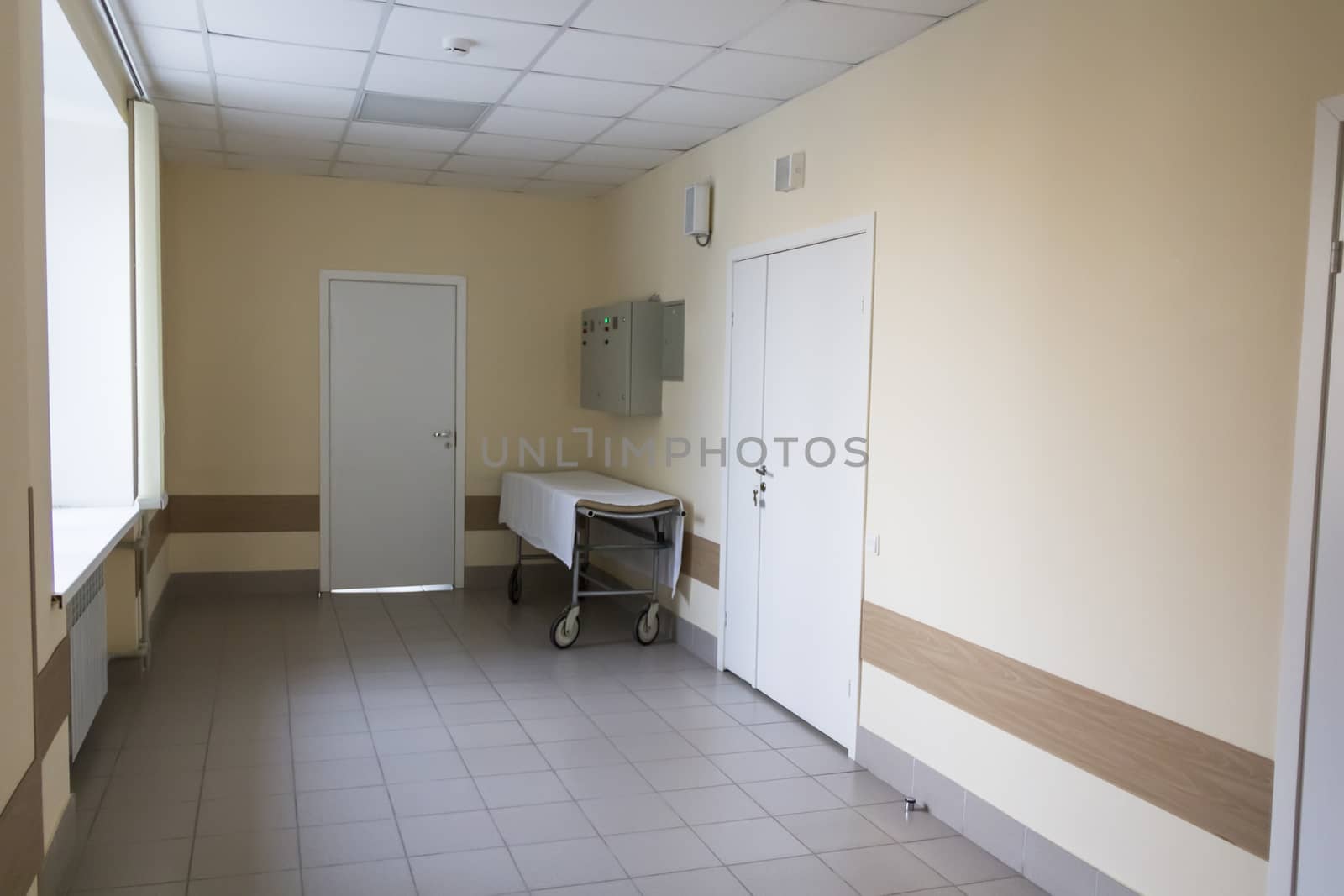 Photo of empty stretcher in hospital corridor