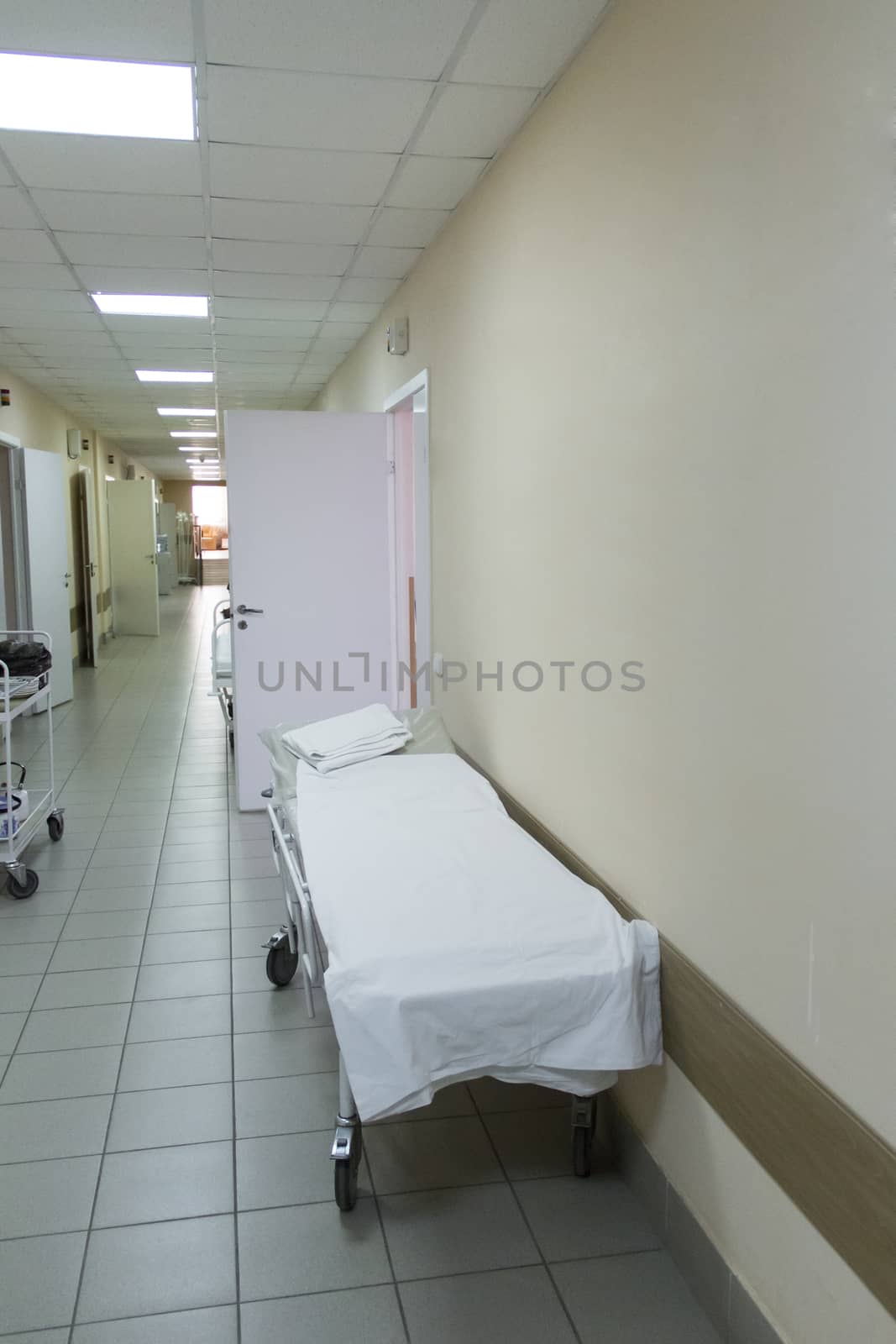 Photo of empty stretcher in hospital corridor