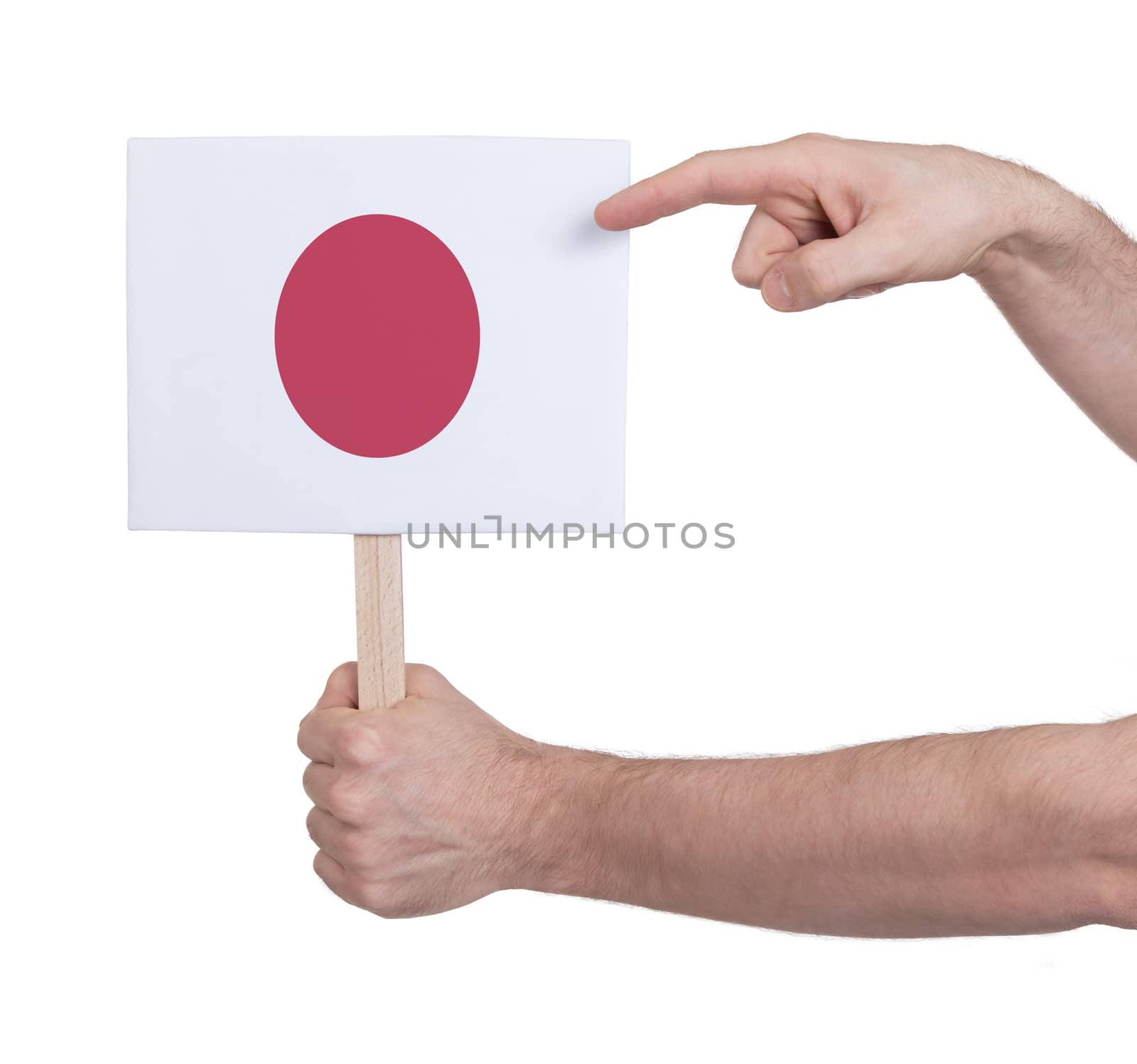 Hand holding small card, isolated on white - Flag of Japan