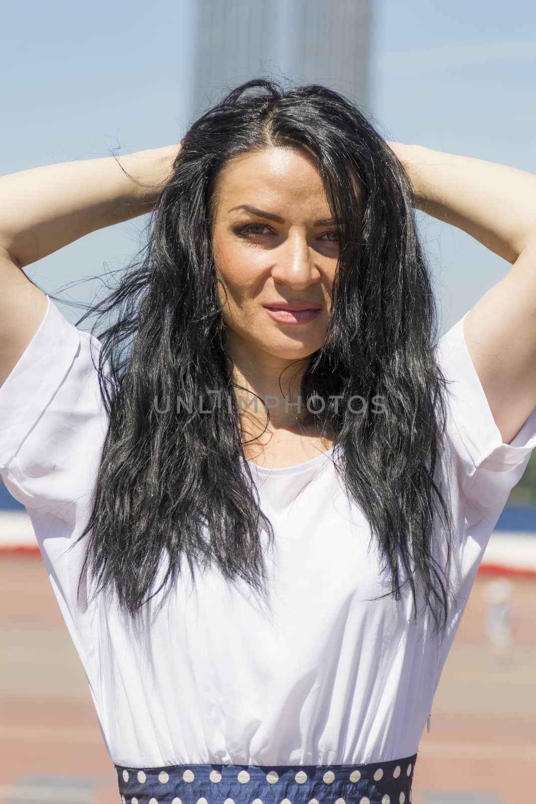 Photo of brunette woman with upward hands