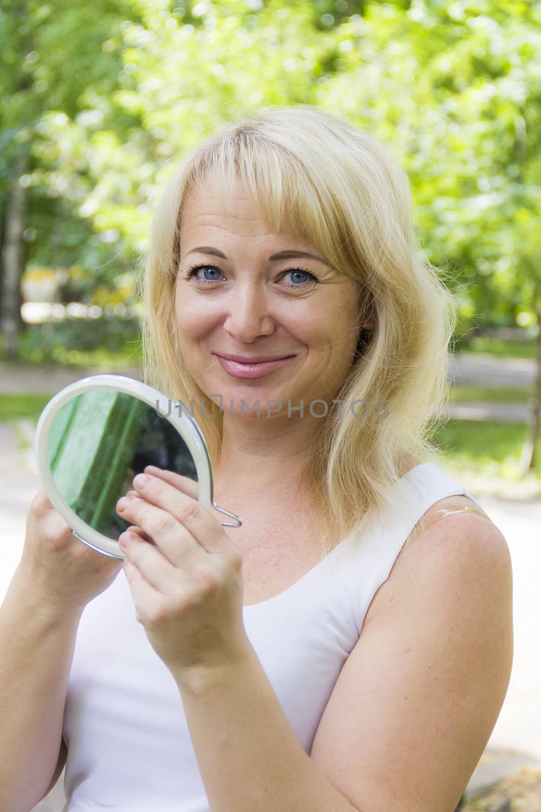 European blond woman looking in the mirror