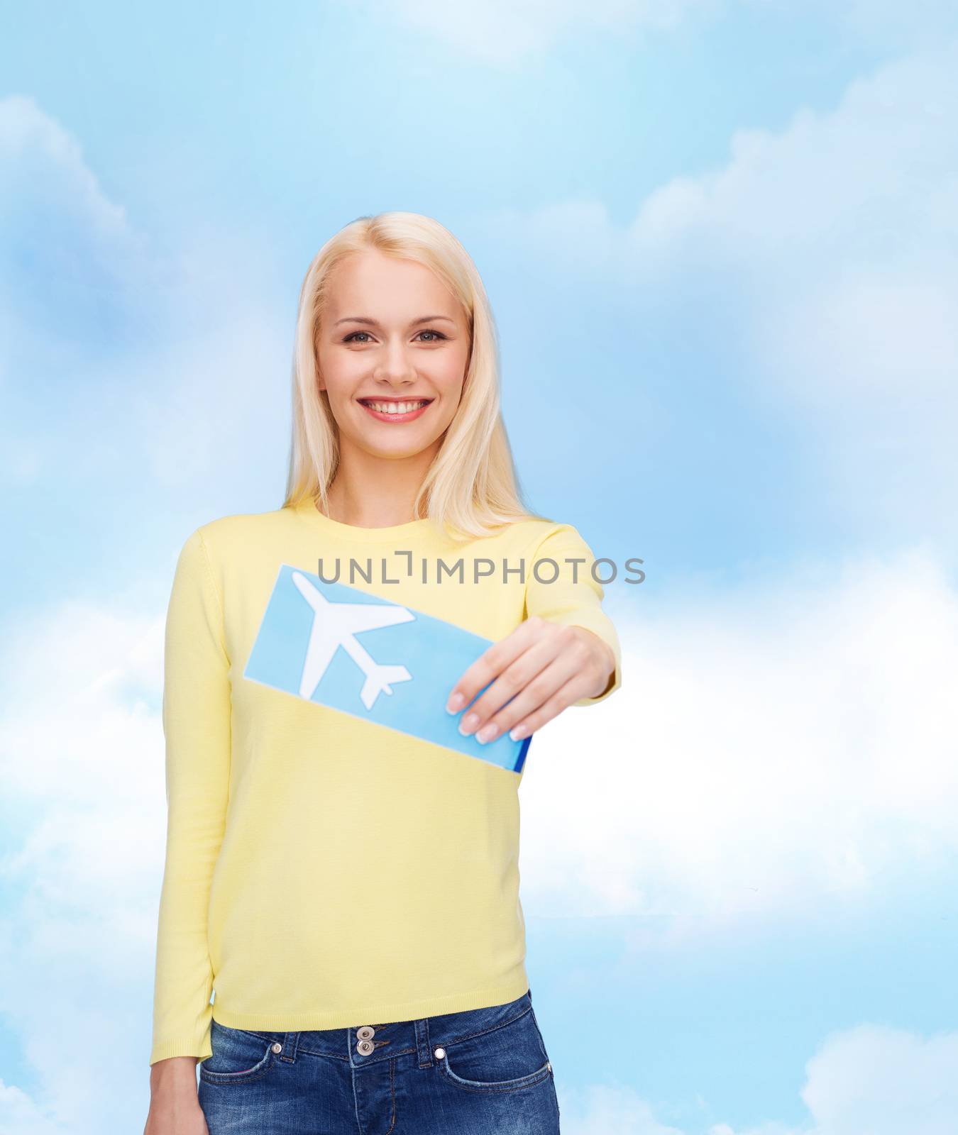 smiling young woman with airplane ticket by dolgachov