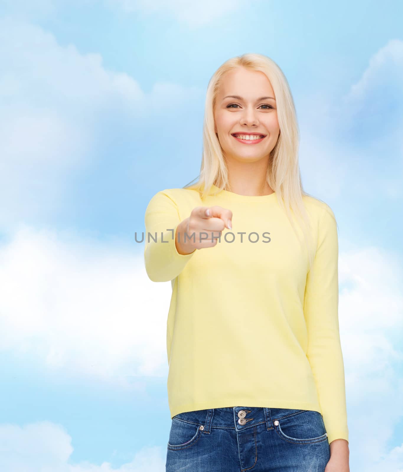 smiling woman pointing finger at you by dolgachov
