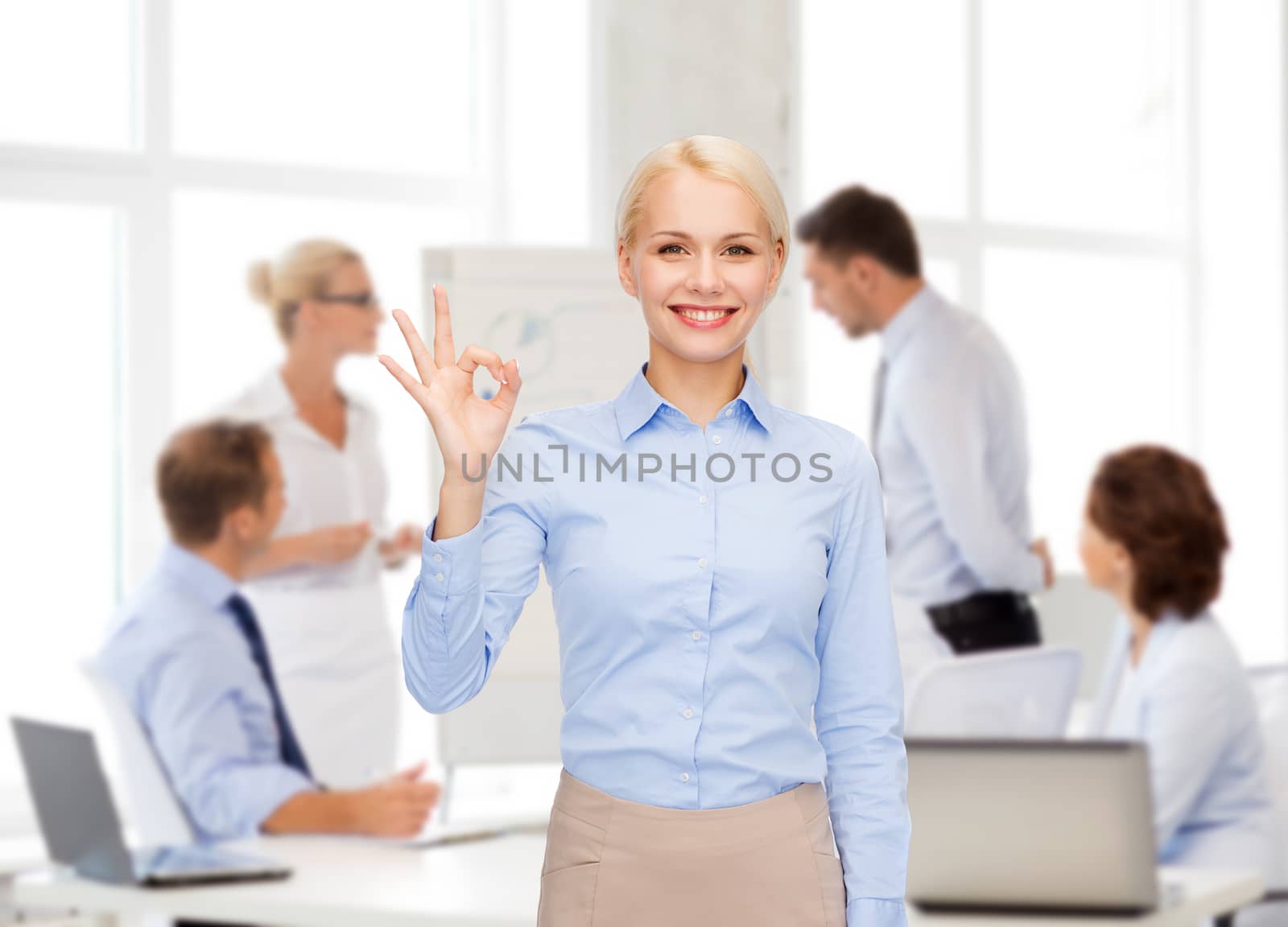 business and education concept - smiling businesswoman showing ok-sign with hand