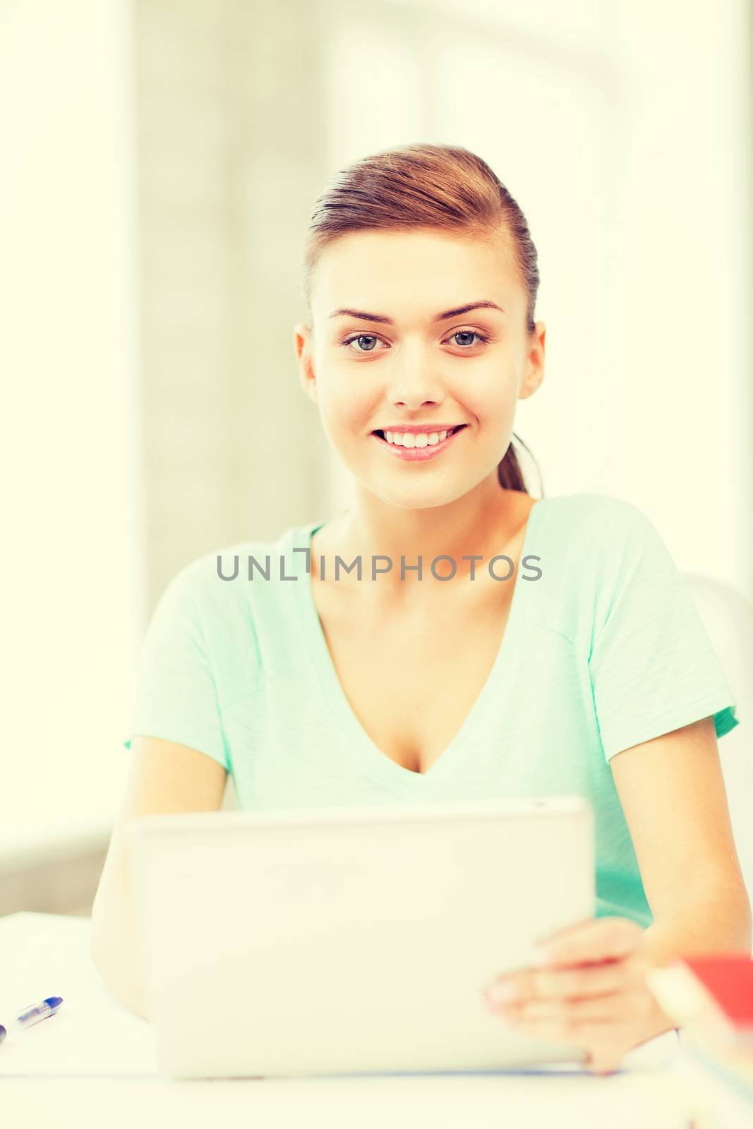 smiling student girl with tablet pc by dolgachov