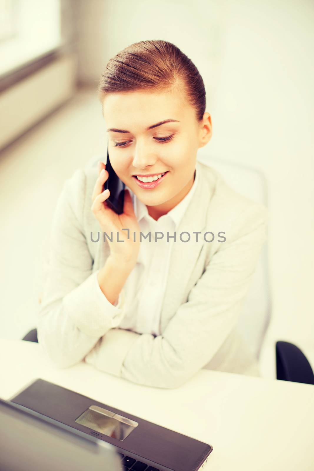 business and communication - smiling businesswoman with smartphone in office