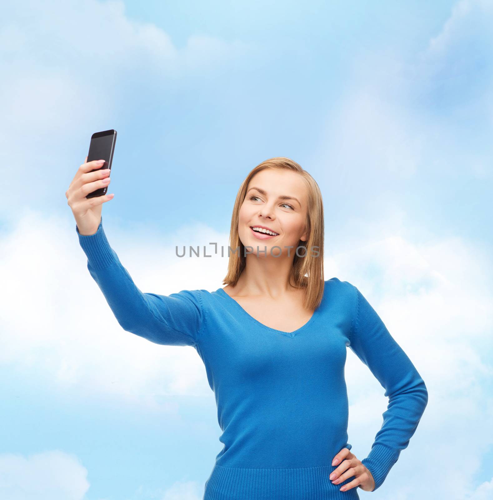 woman taking self picture with smartphone camera by dolgachov