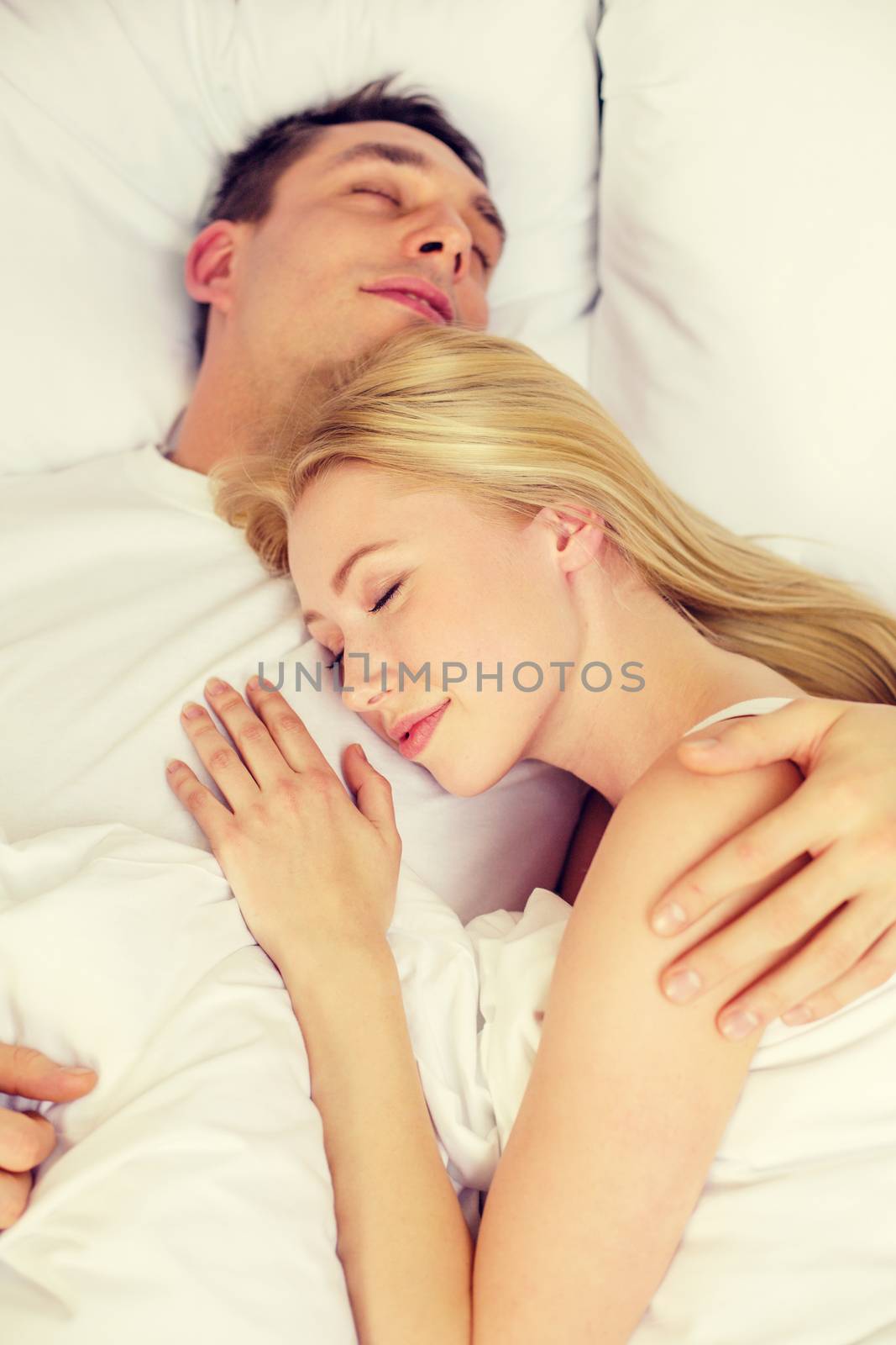 happy couple sleeping in bed by dolgachov