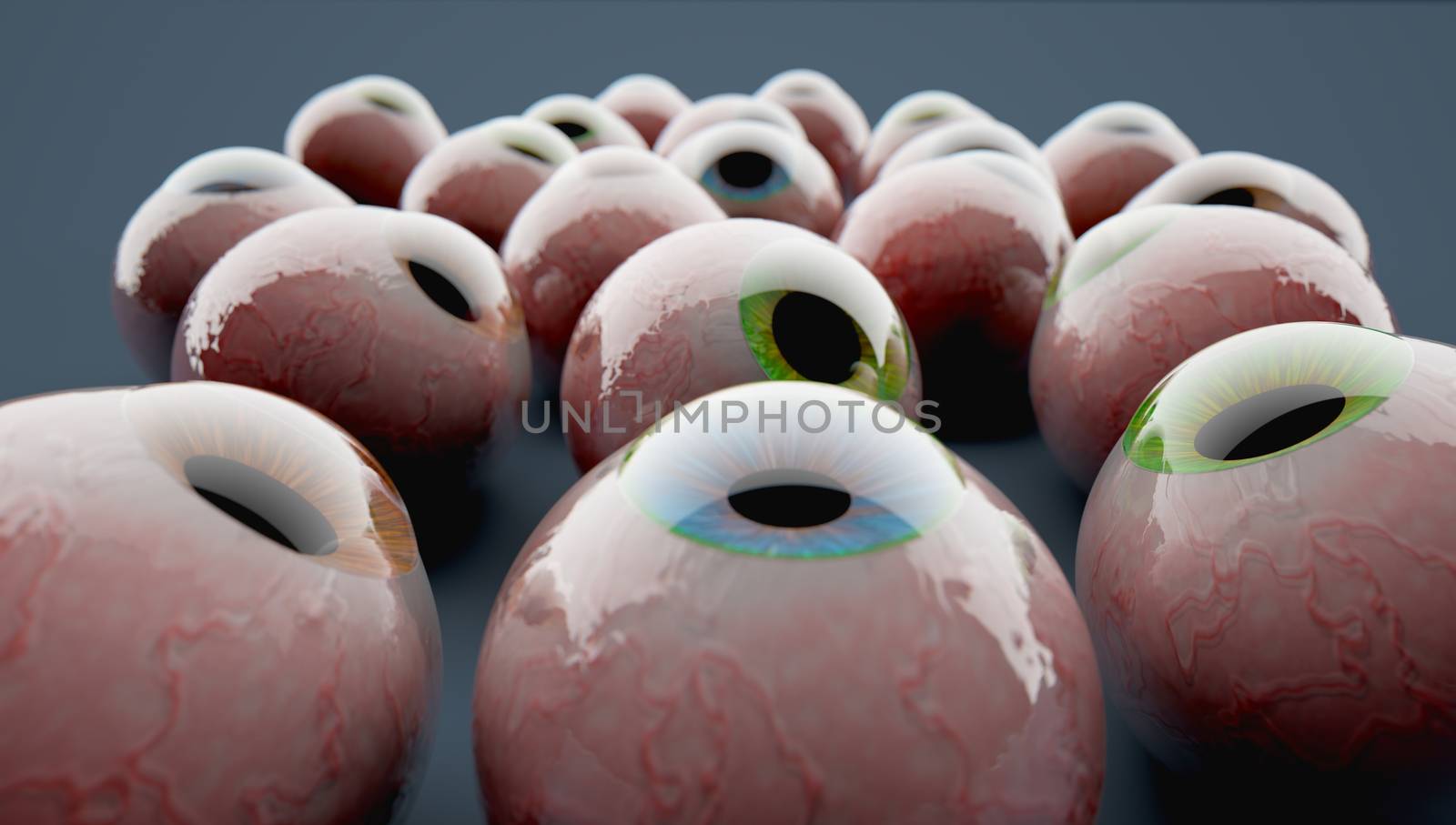 A Close-up of a couple of colorful eyeballs grouped on a grey surface