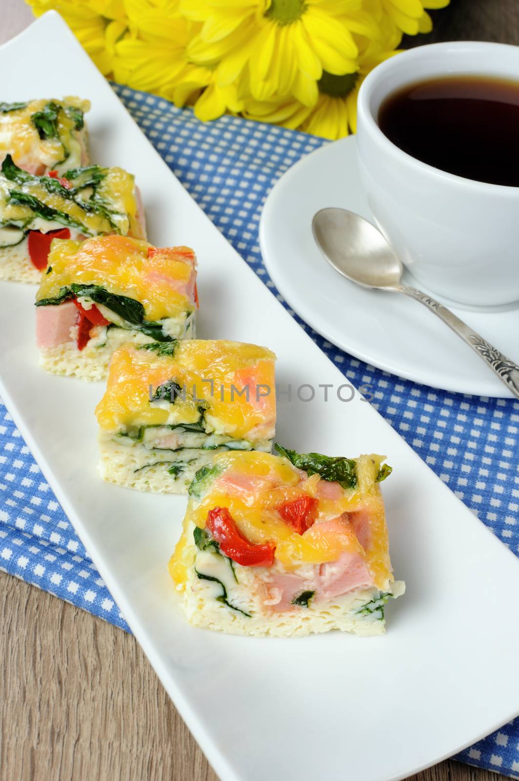 Canape of omelet with spinach, sausage and a cup of coffee