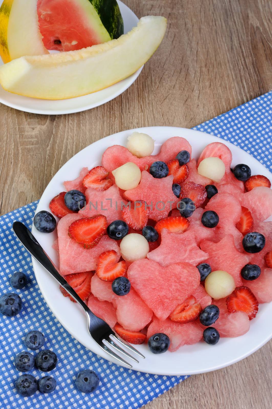 salad of blueberries, watermelon hearts, stars, balls of melon and strawberries