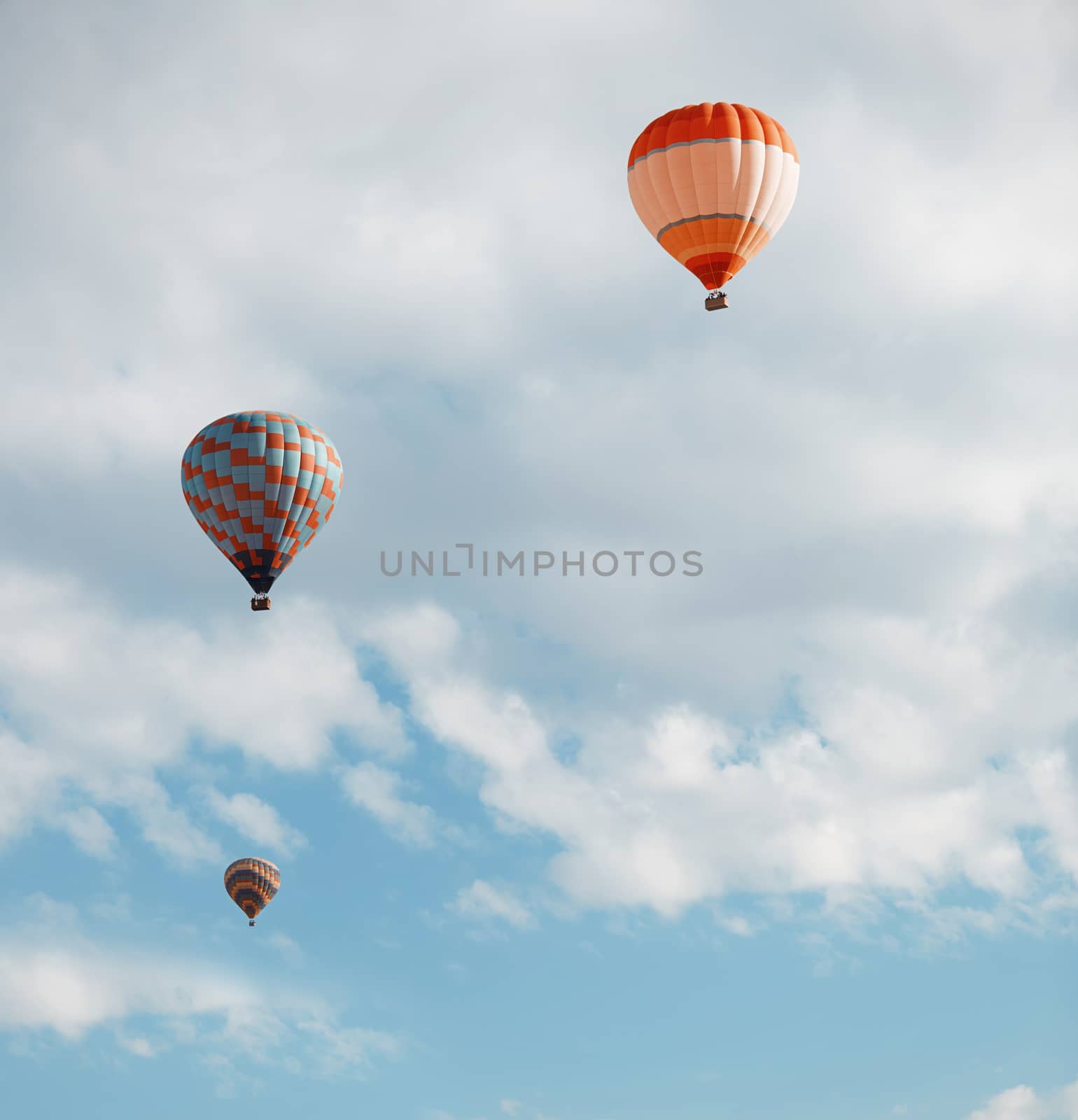 Three air balloons  in blue sky. Vertical photo